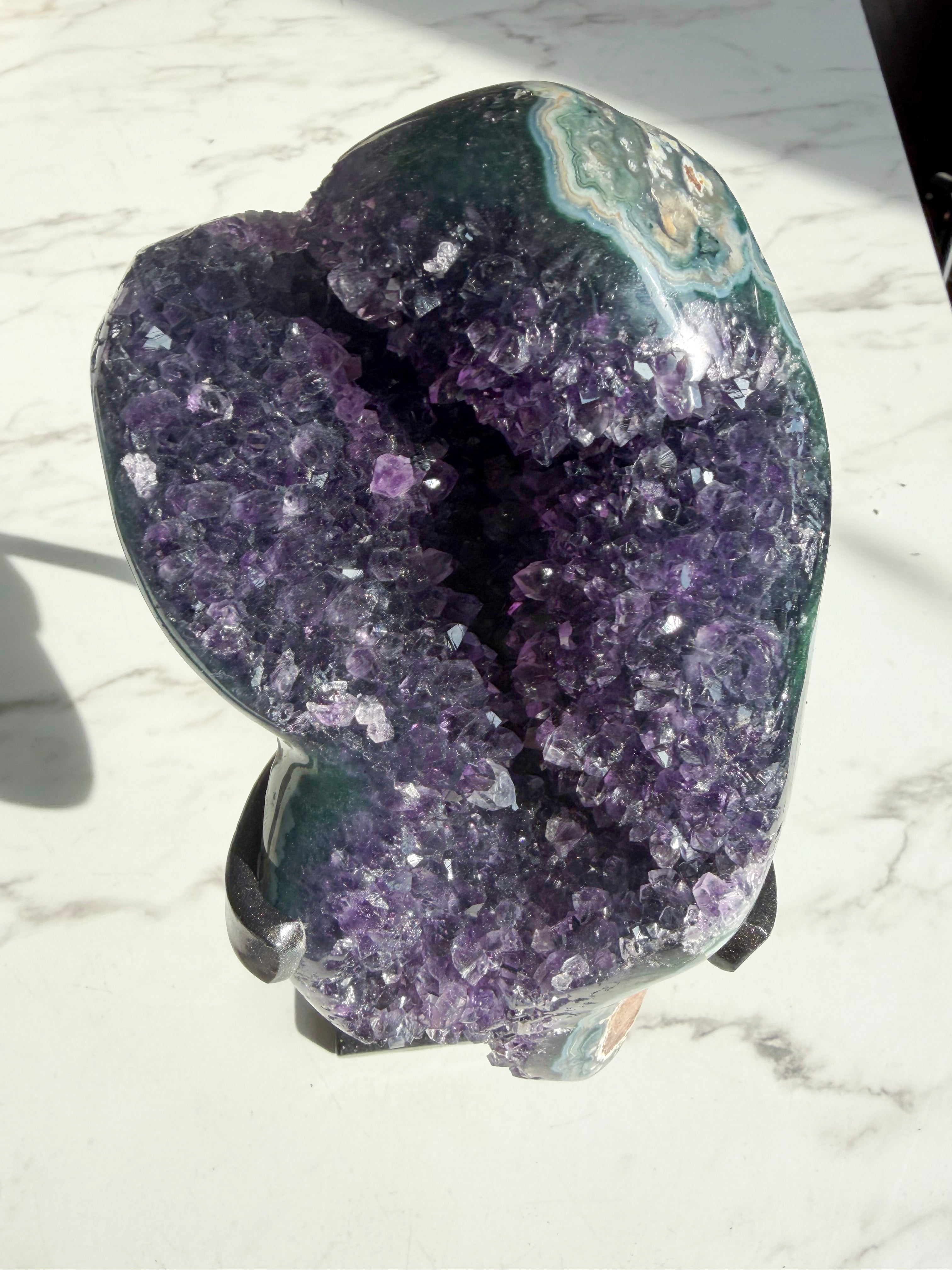 amethyst mineral with green agate banding on the edges.