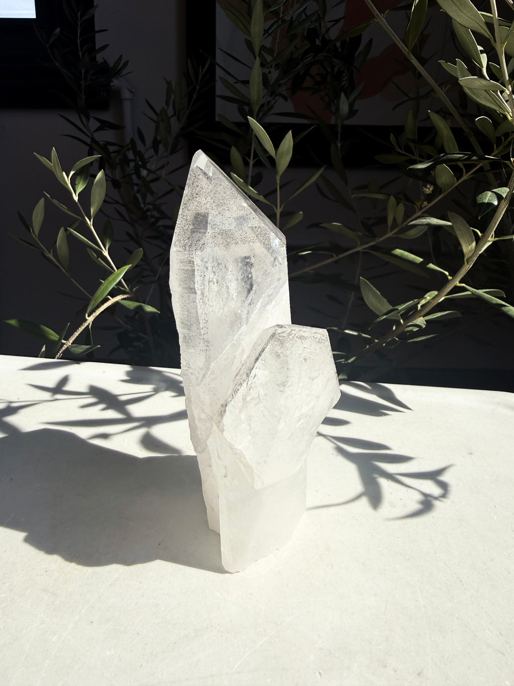natural black phantom lemurian quartz cluster on marble counter