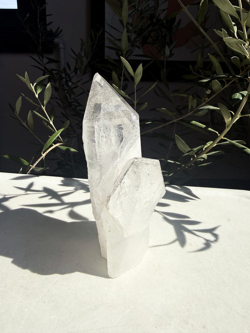 natural black phantom lemurian quartz cluster on marble counter