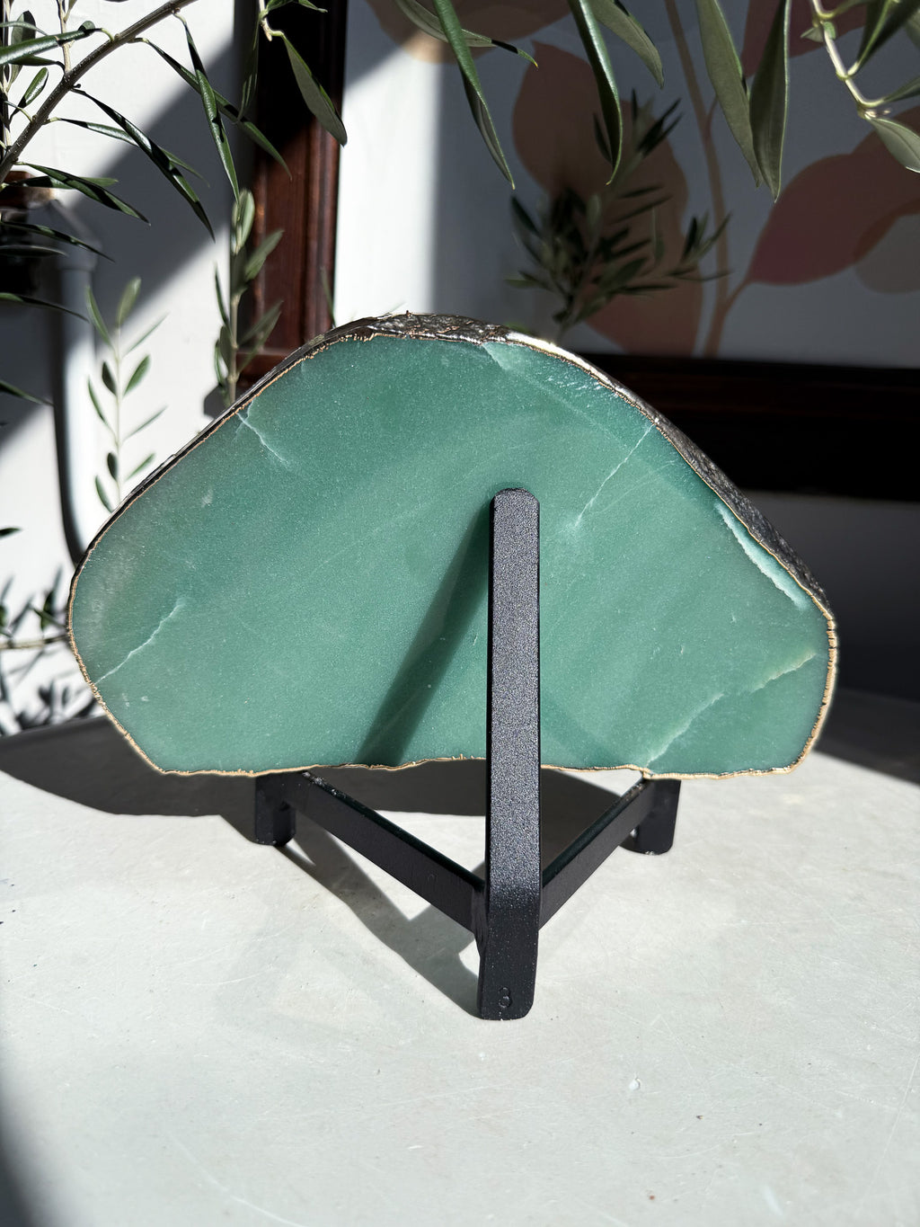 Black Iron Display stand holding turqoiuse mineral
