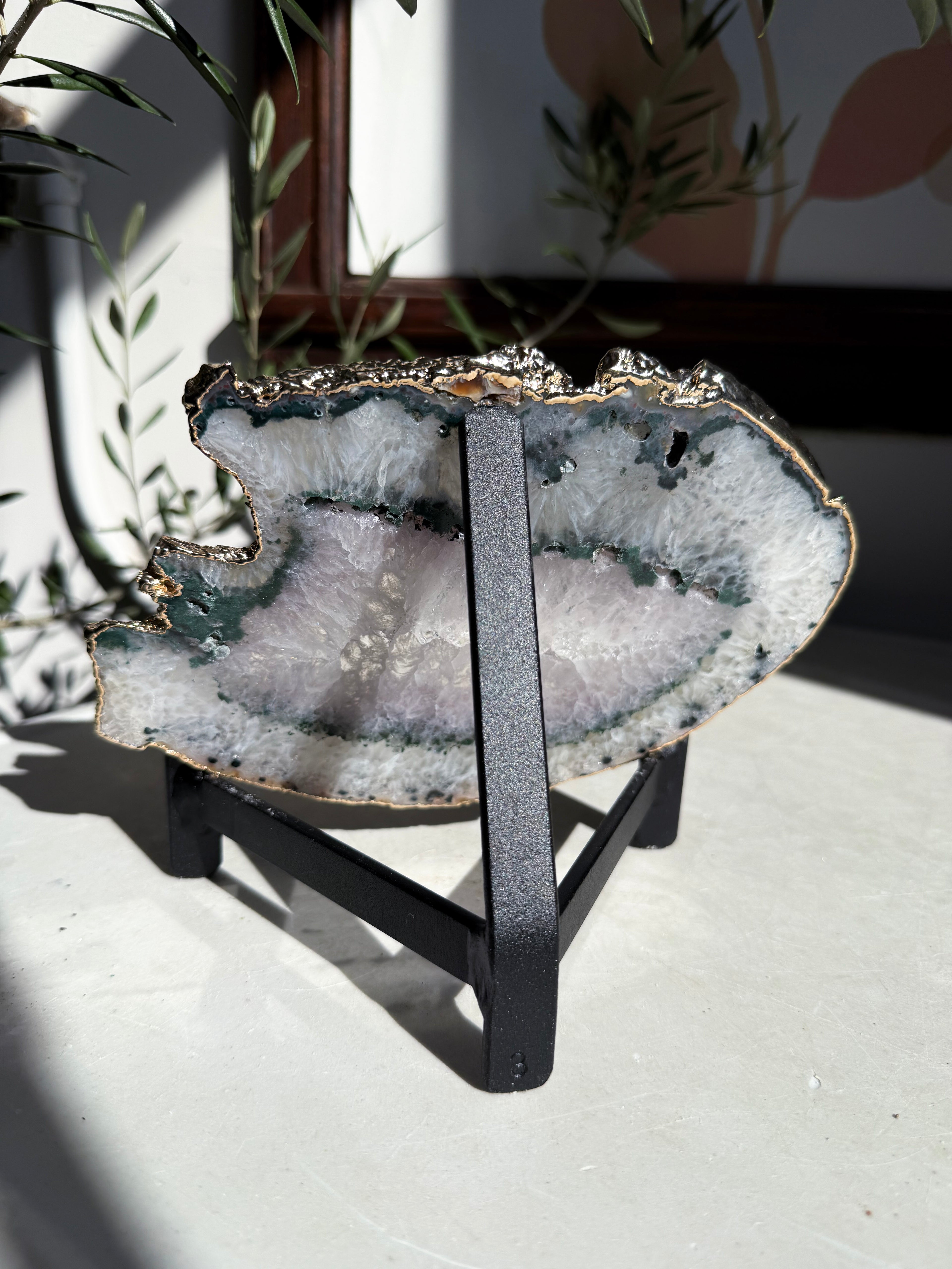 agate slice with gold trim on stand