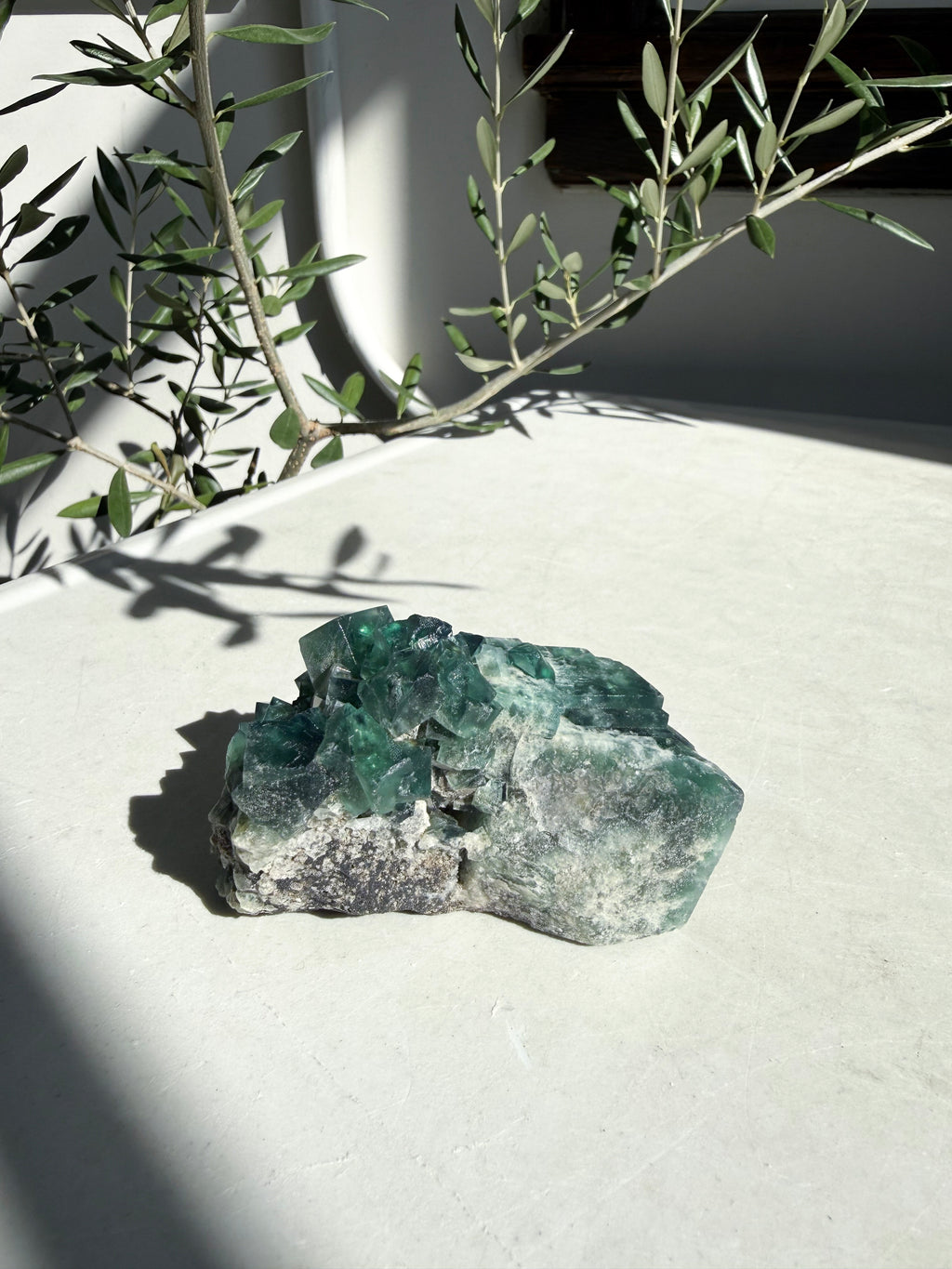 Bright green fluorite on marble counter