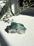 Bright green fluorite on marble counter