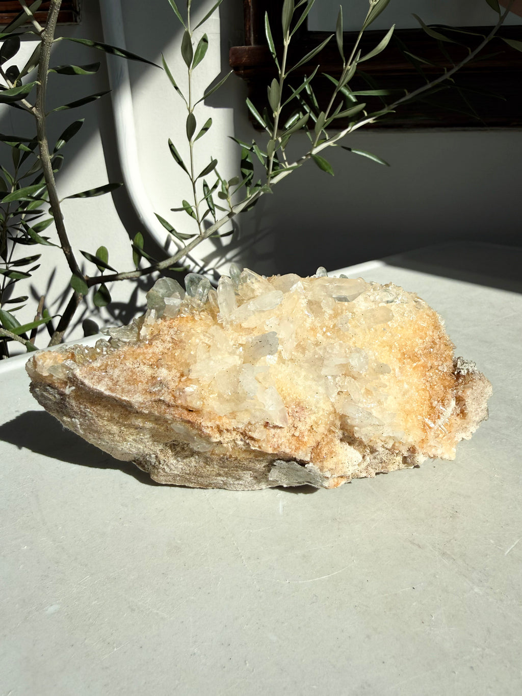 Chlorite and iron quartz cluster on white marble counter