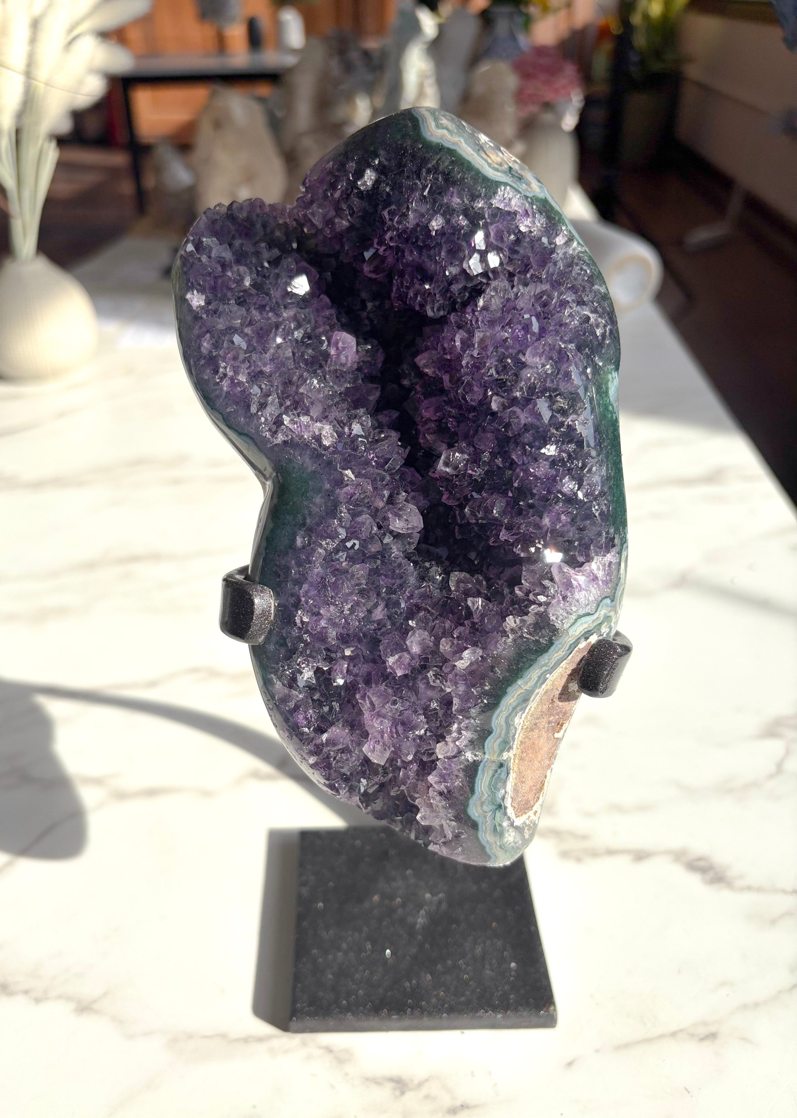 raw amethyst mineral with polished green agate banding on the edges