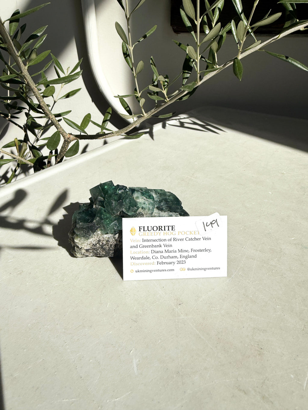 green flourite with locale card in front on marble counter