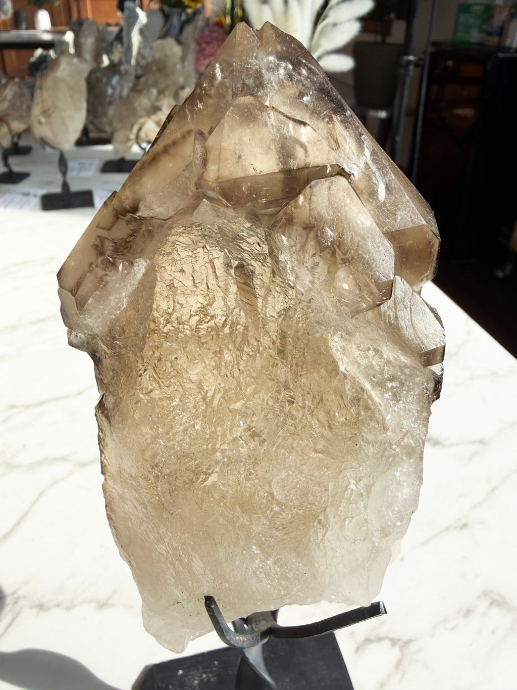 Close up smokey Citrine on Custom Stand over white counter