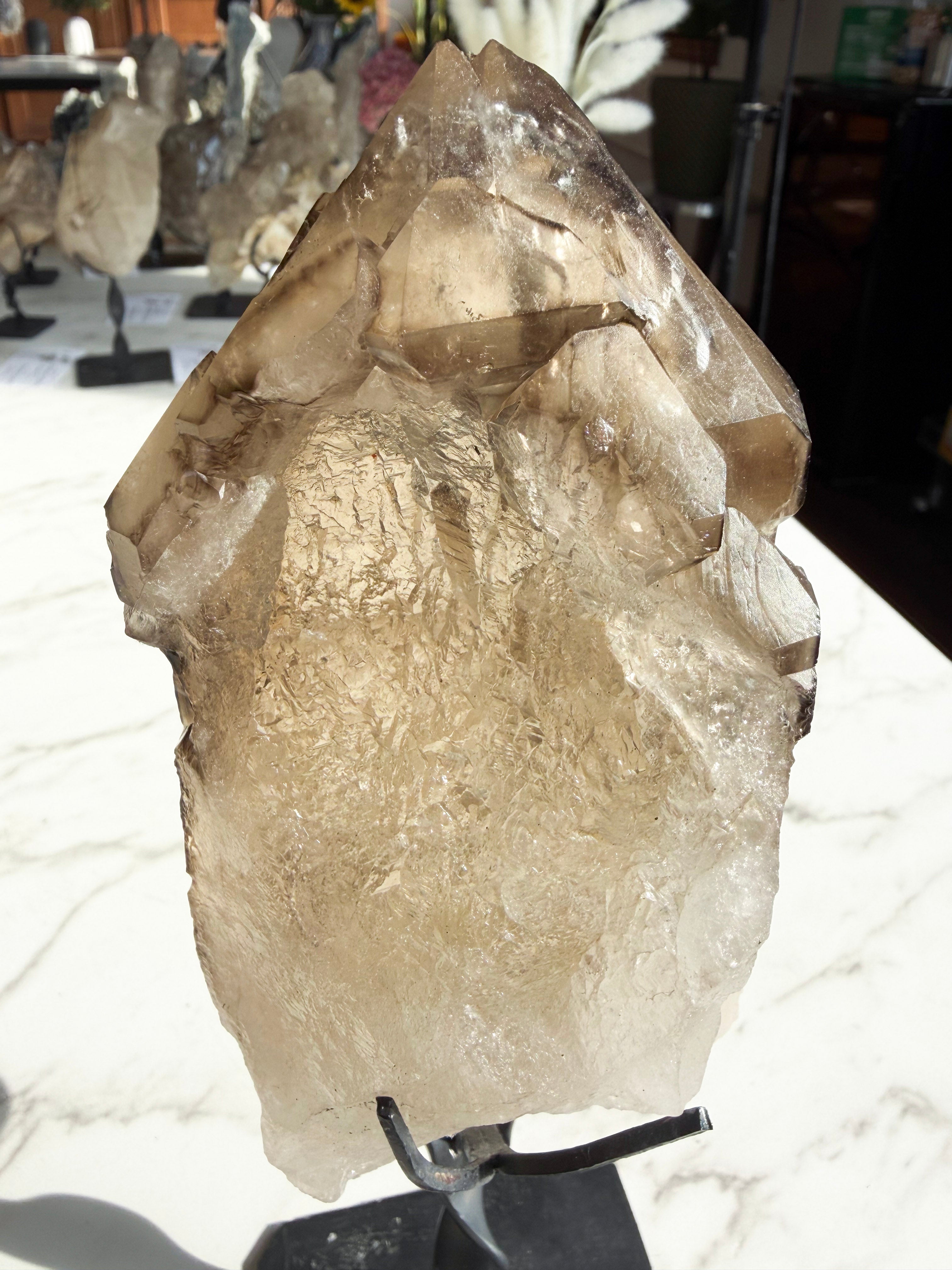 Close up smokey Citrine on Custom Stand over white counter