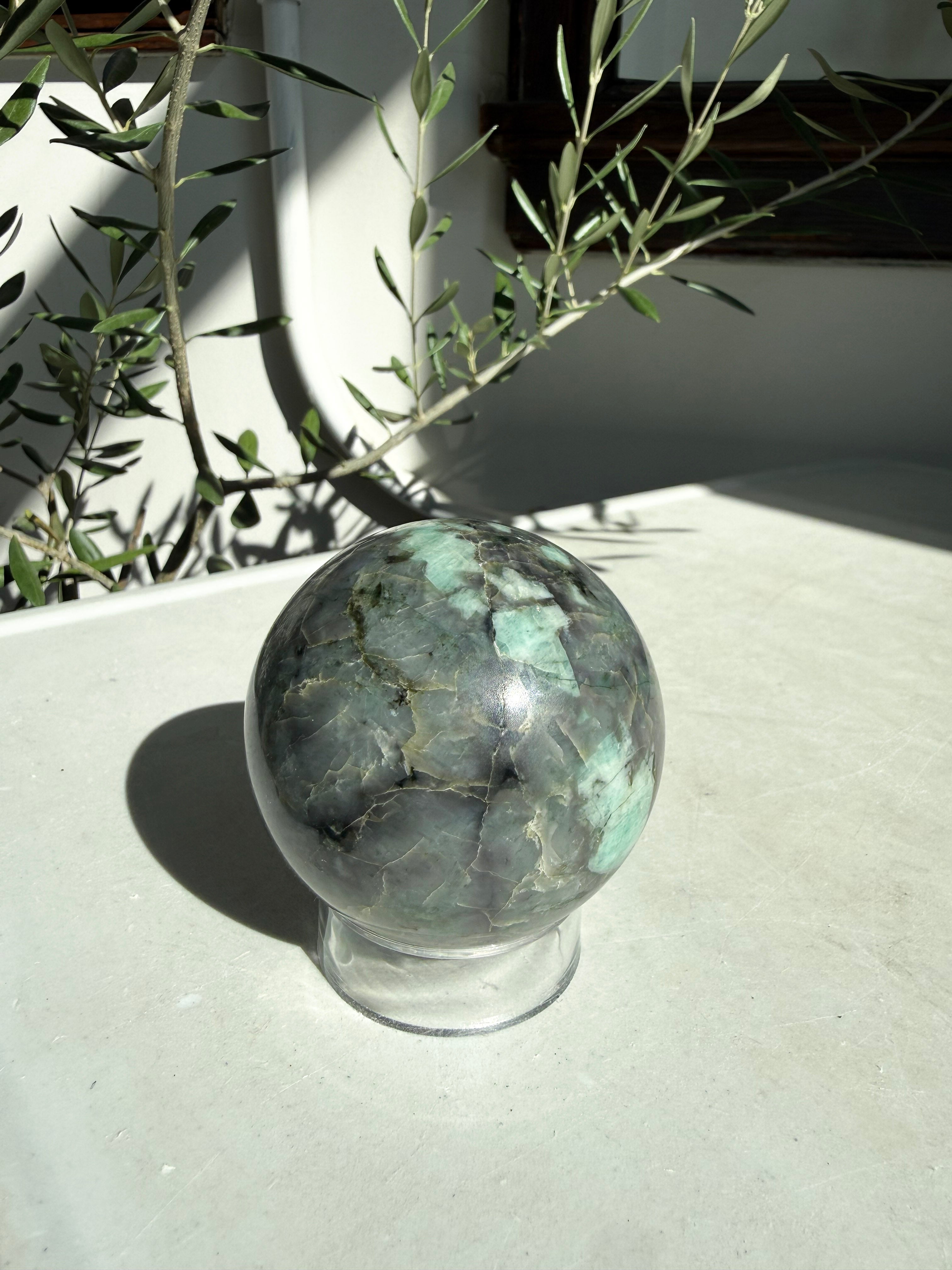 turquoise and gray emerald sphere on stand