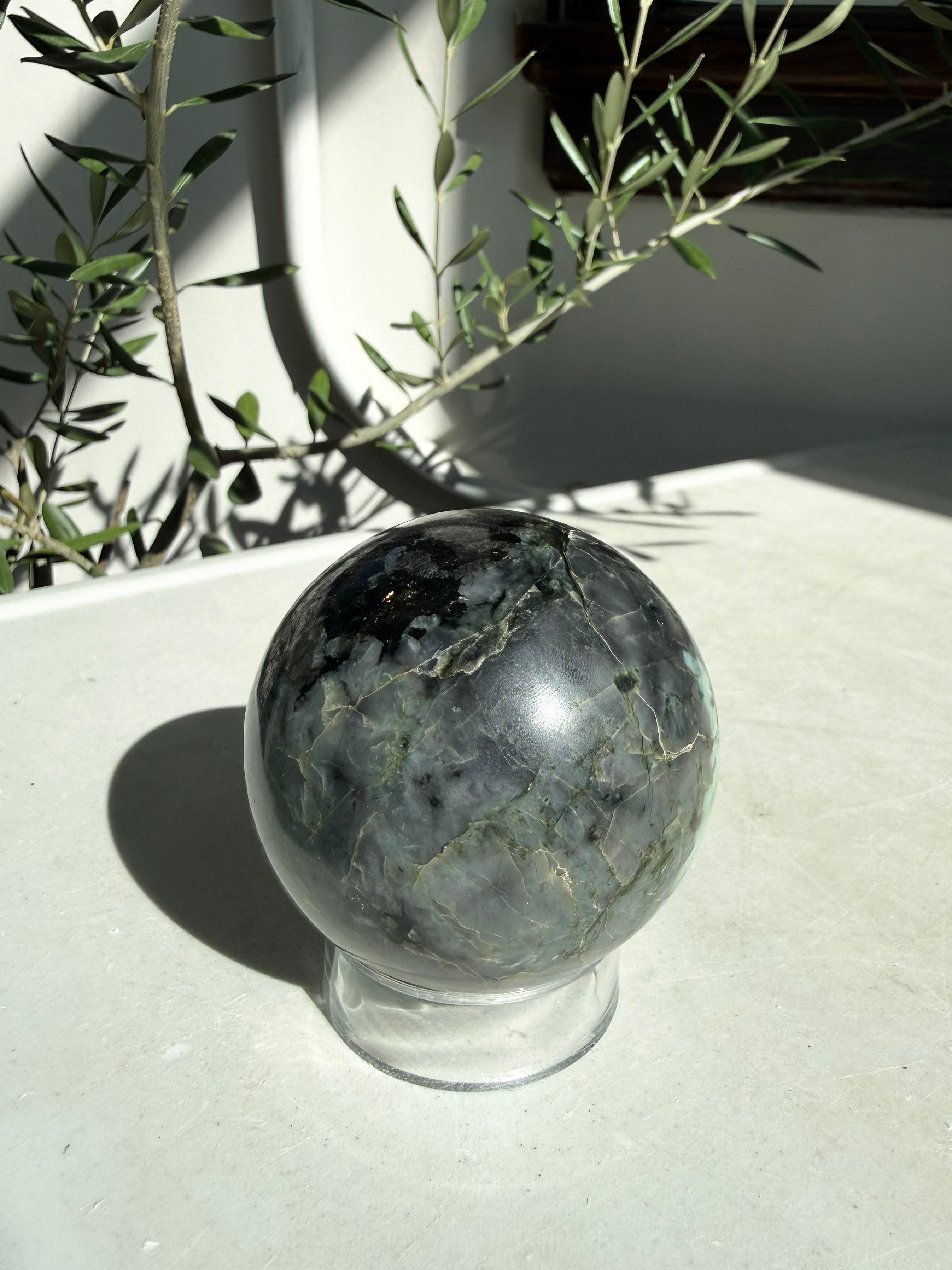 deep gray emerald sphere on stand