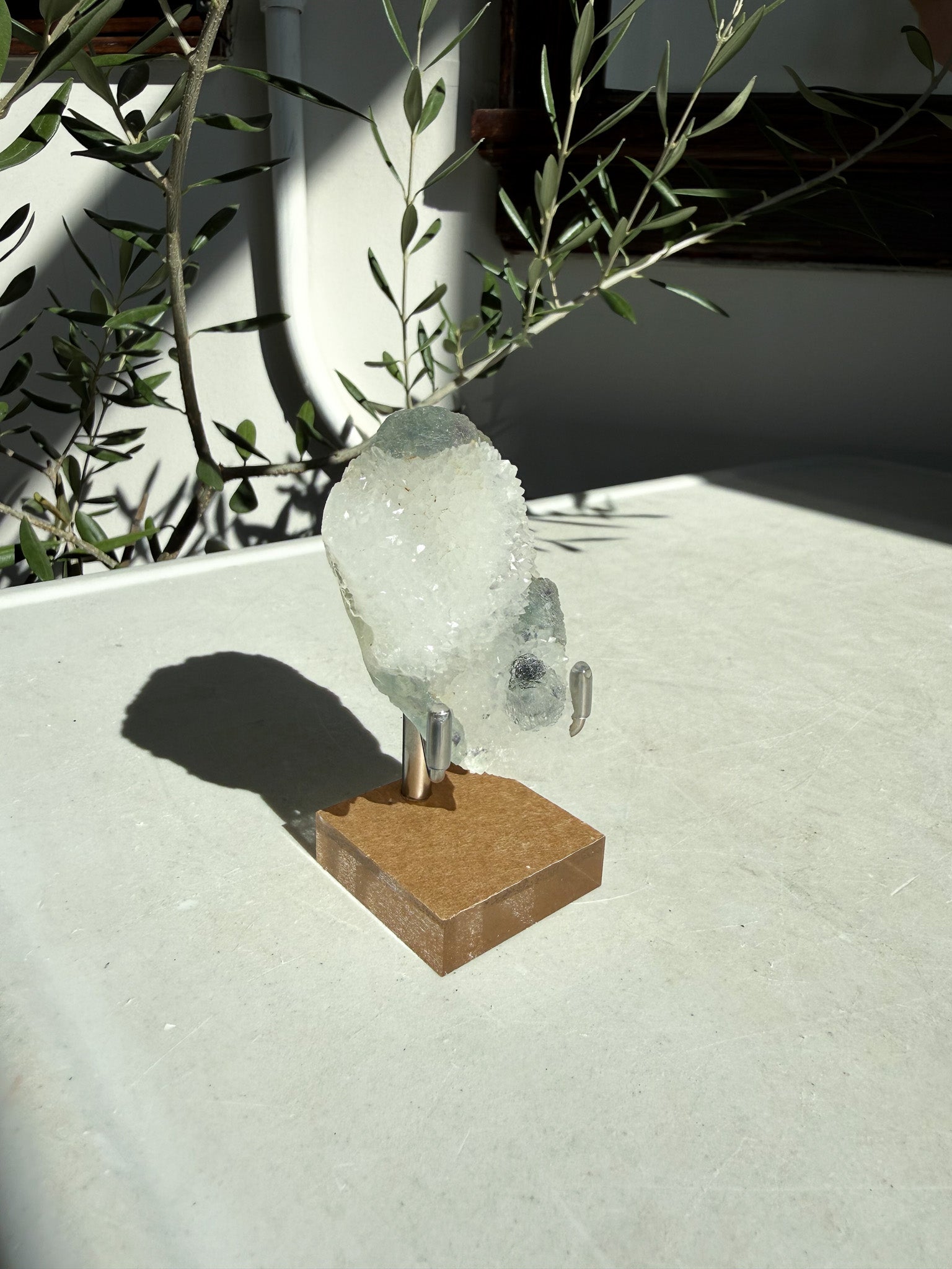 crystal stone on bronze stand with green accents
