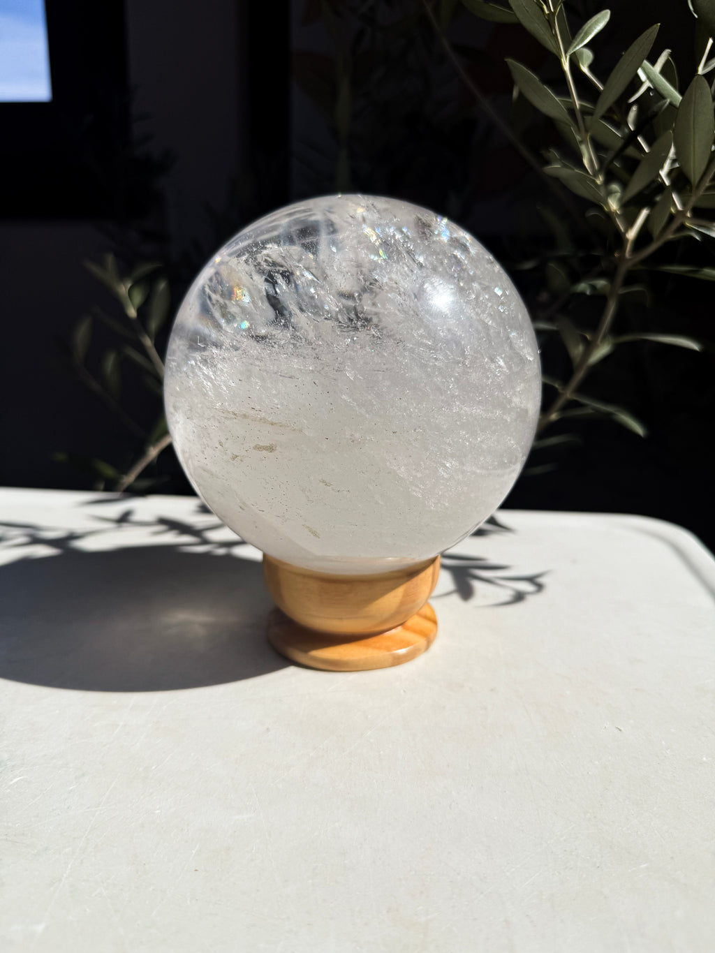 brazilian quartz globe on wooden stand on marble countertop