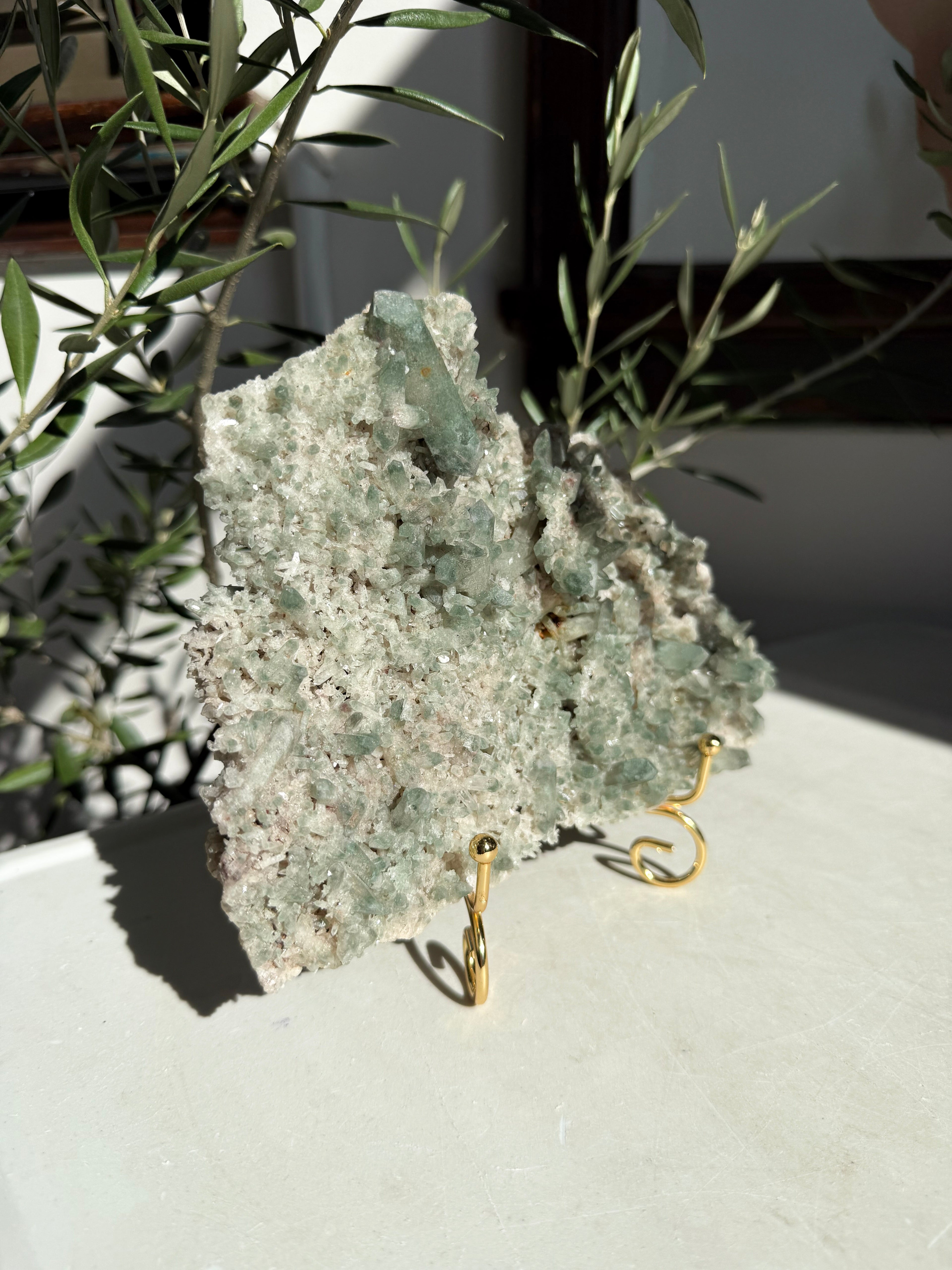 Chlorite quartz cluster on sitting on marble counter