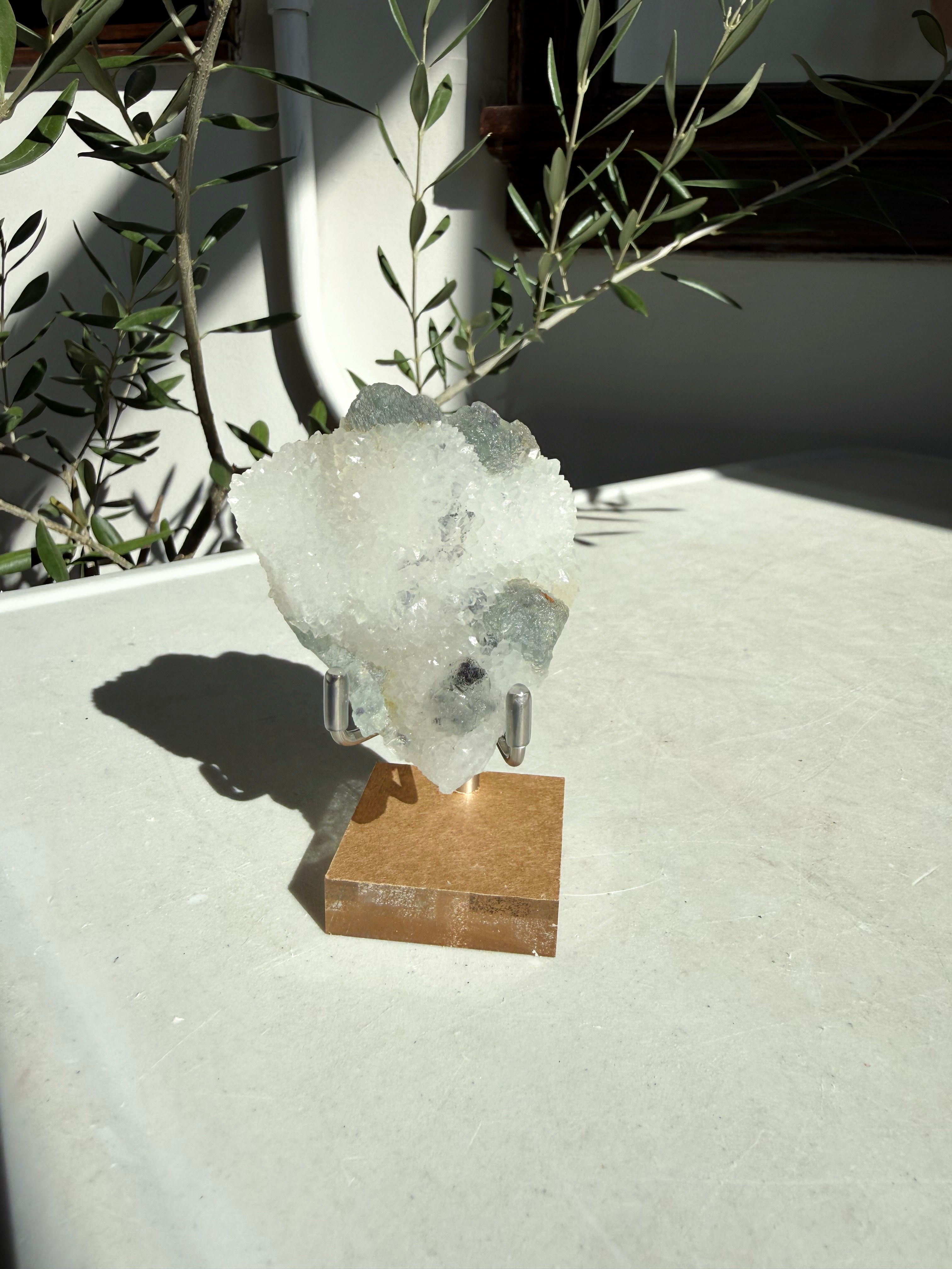 crystal stone on bronze stand with green accents