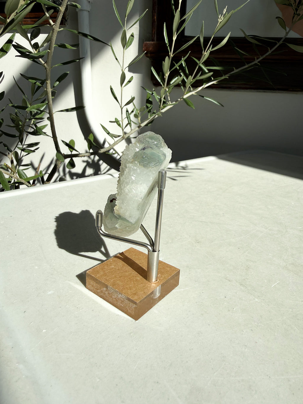Green fluorite druzy quartz on white marble counter