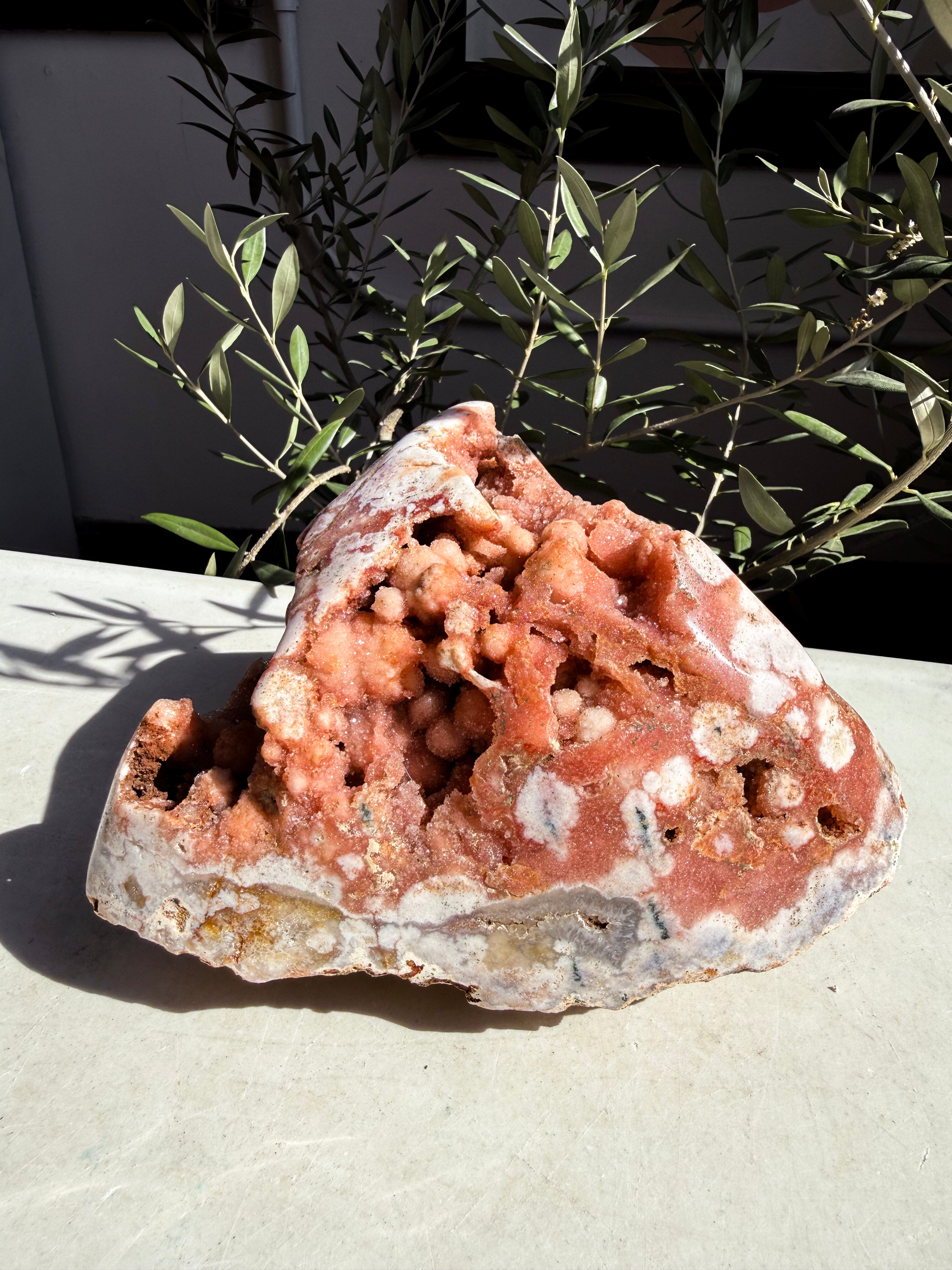 bright pink amethyst with botryoidal druzy  on white marble counter