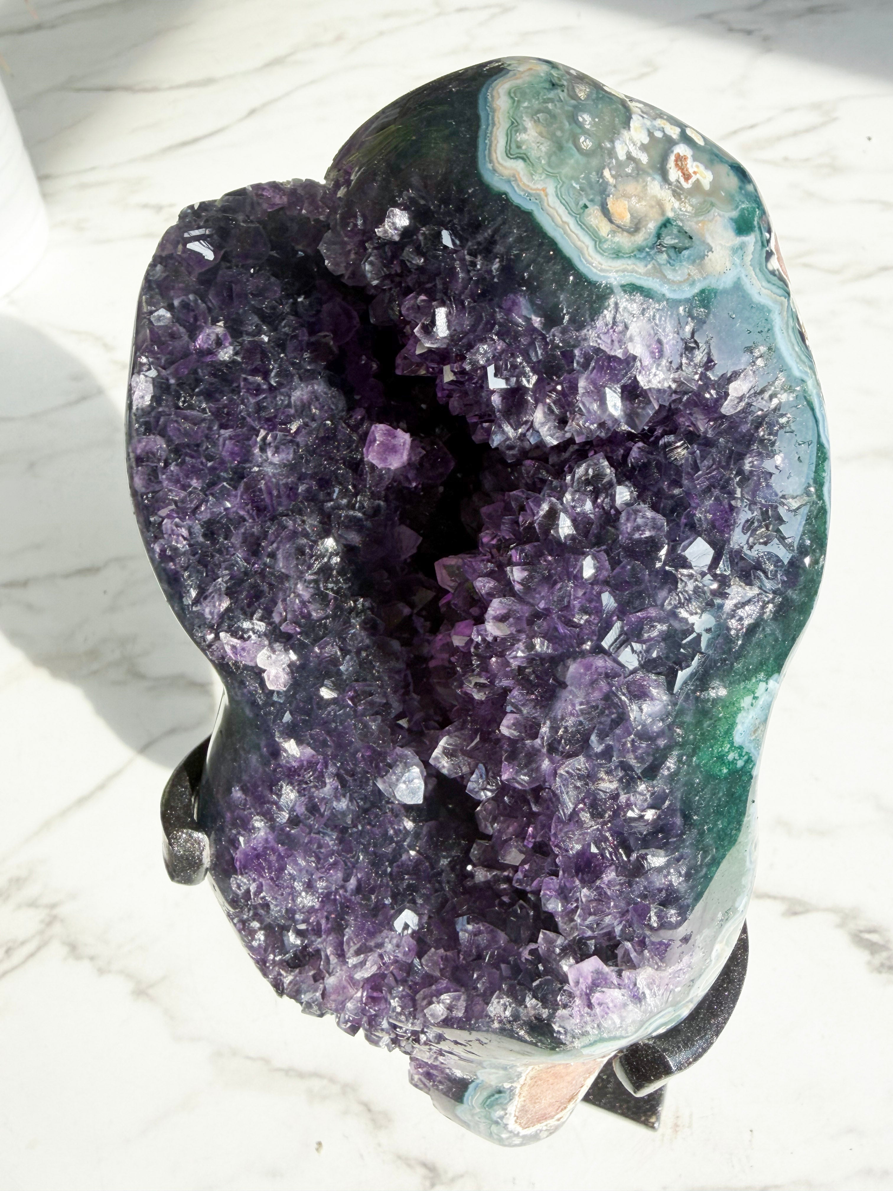 close up of amethyst mineral with polished green agate banding