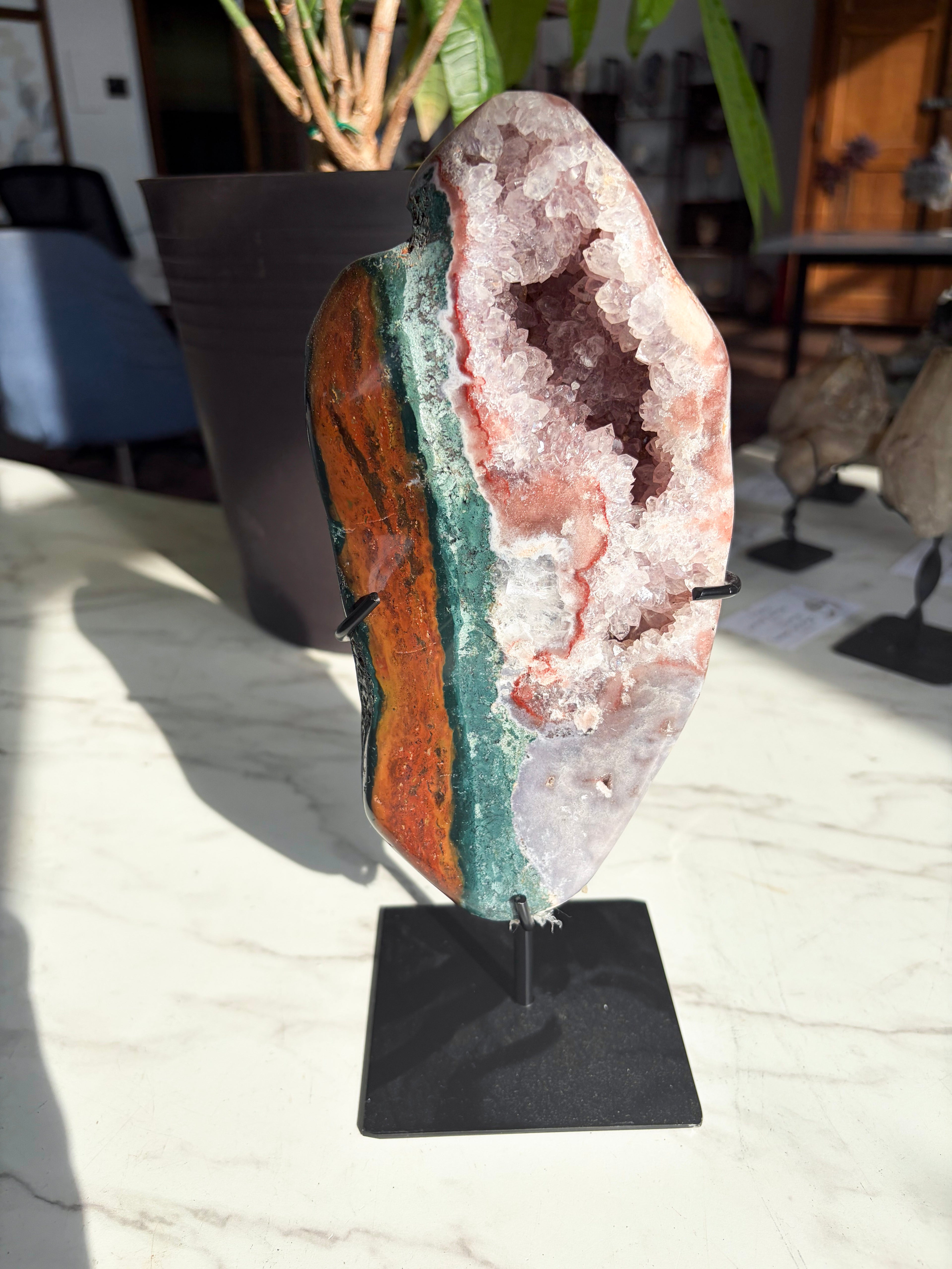 pink amethyst druzy with vibrant red and green jasper crystals on stand