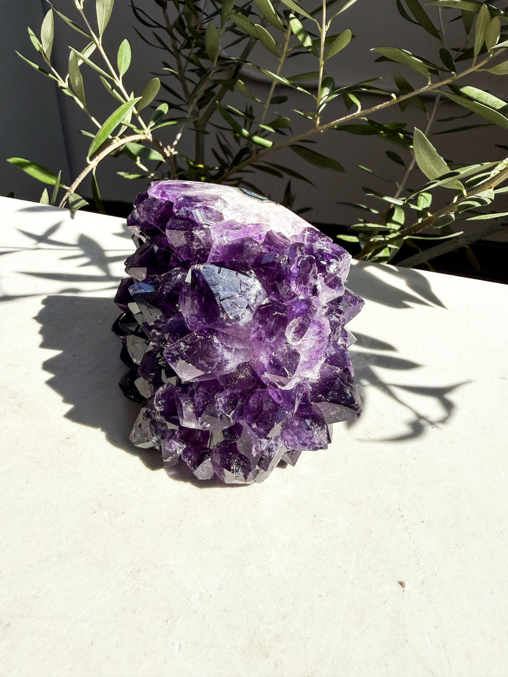 dark purple side-polished amethyst on marble counter