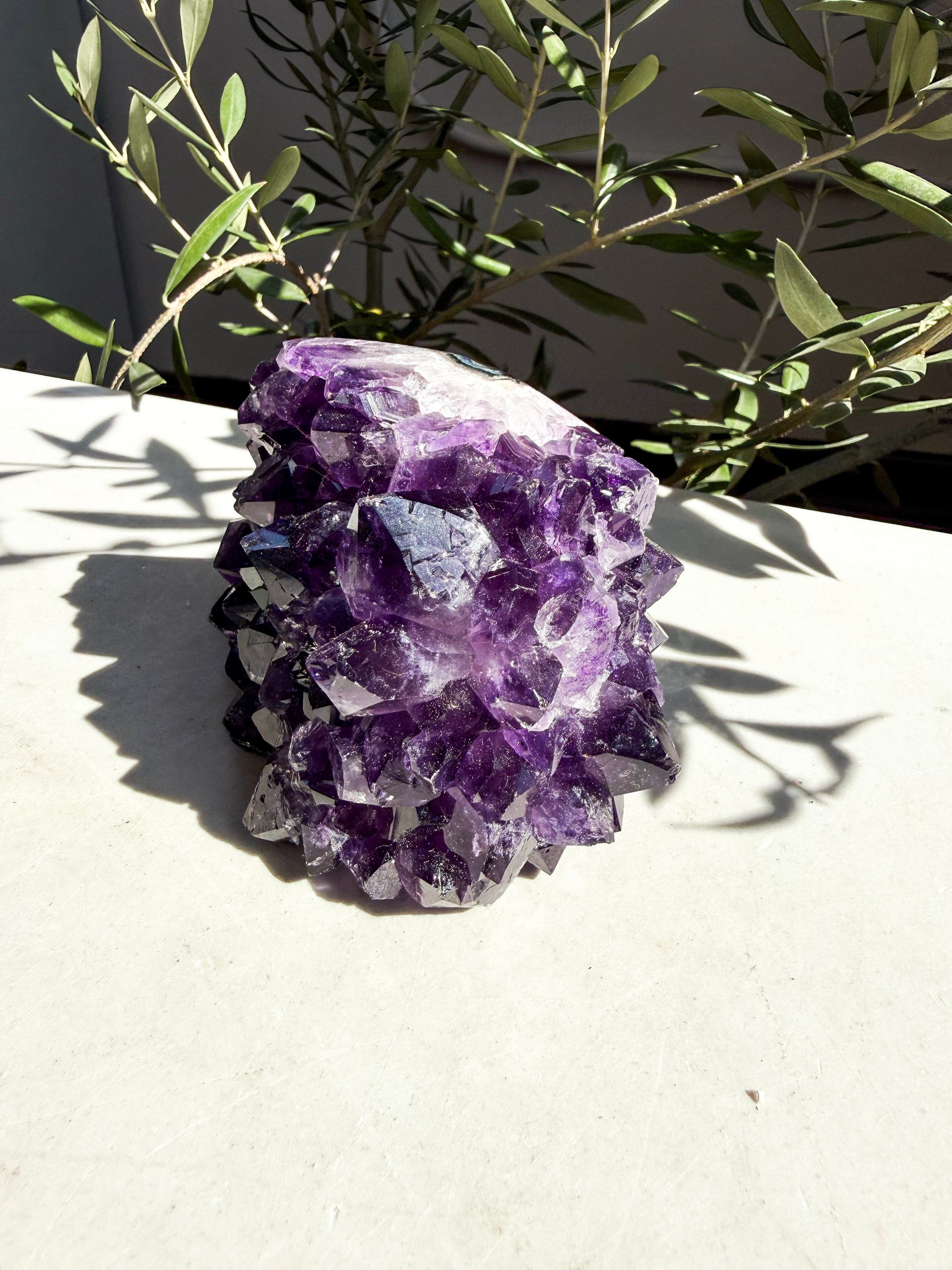 dark purple side-polished amethyst on marble counter