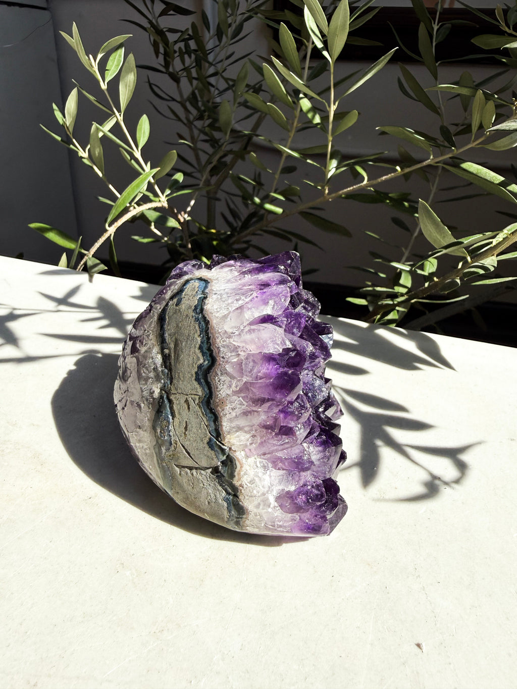 back side of dark purple amethyst on marble counter