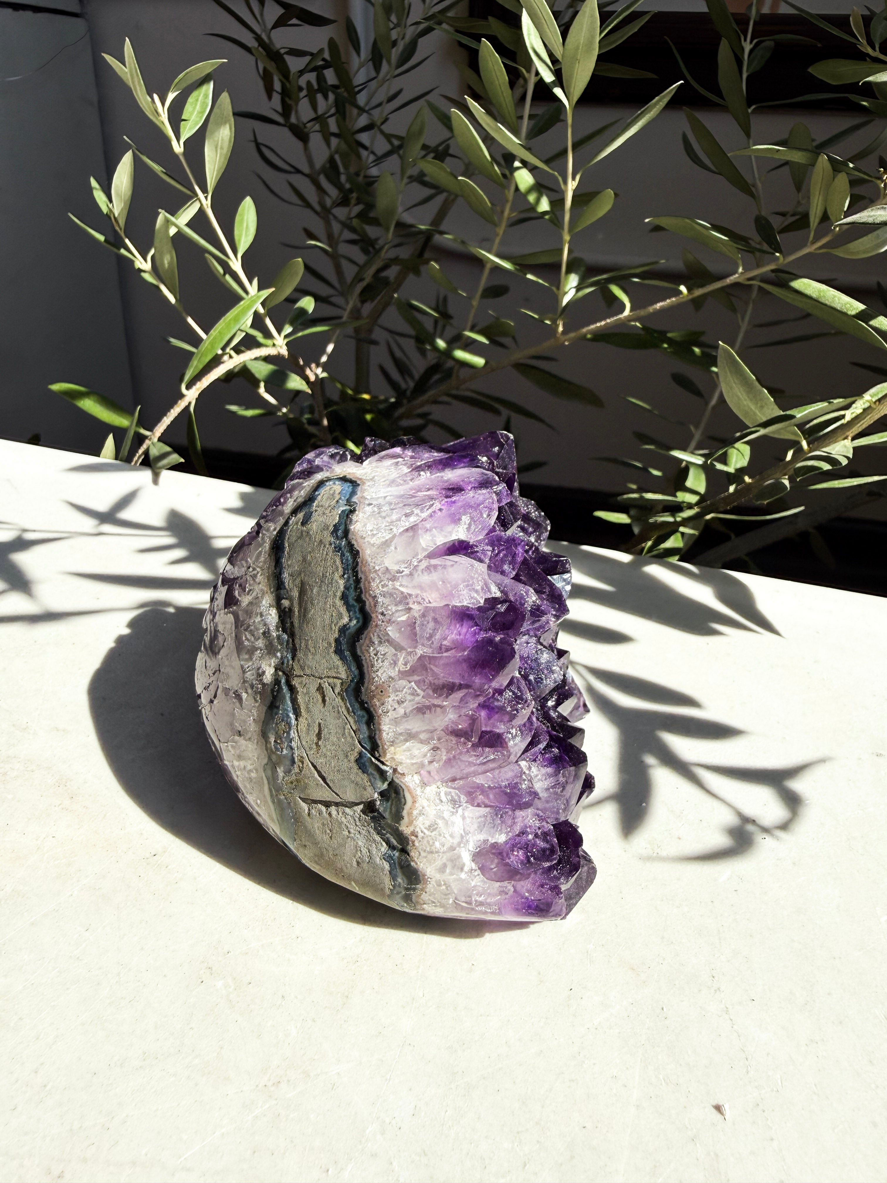back side of dark purple amethyst on marble counter