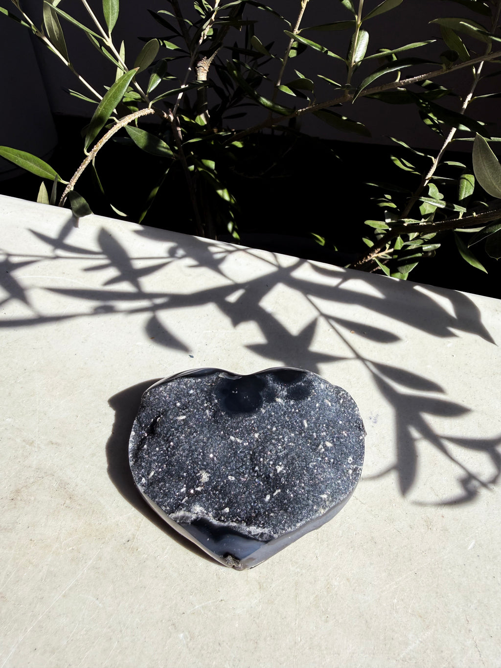 navy druzy agate heart on marble background