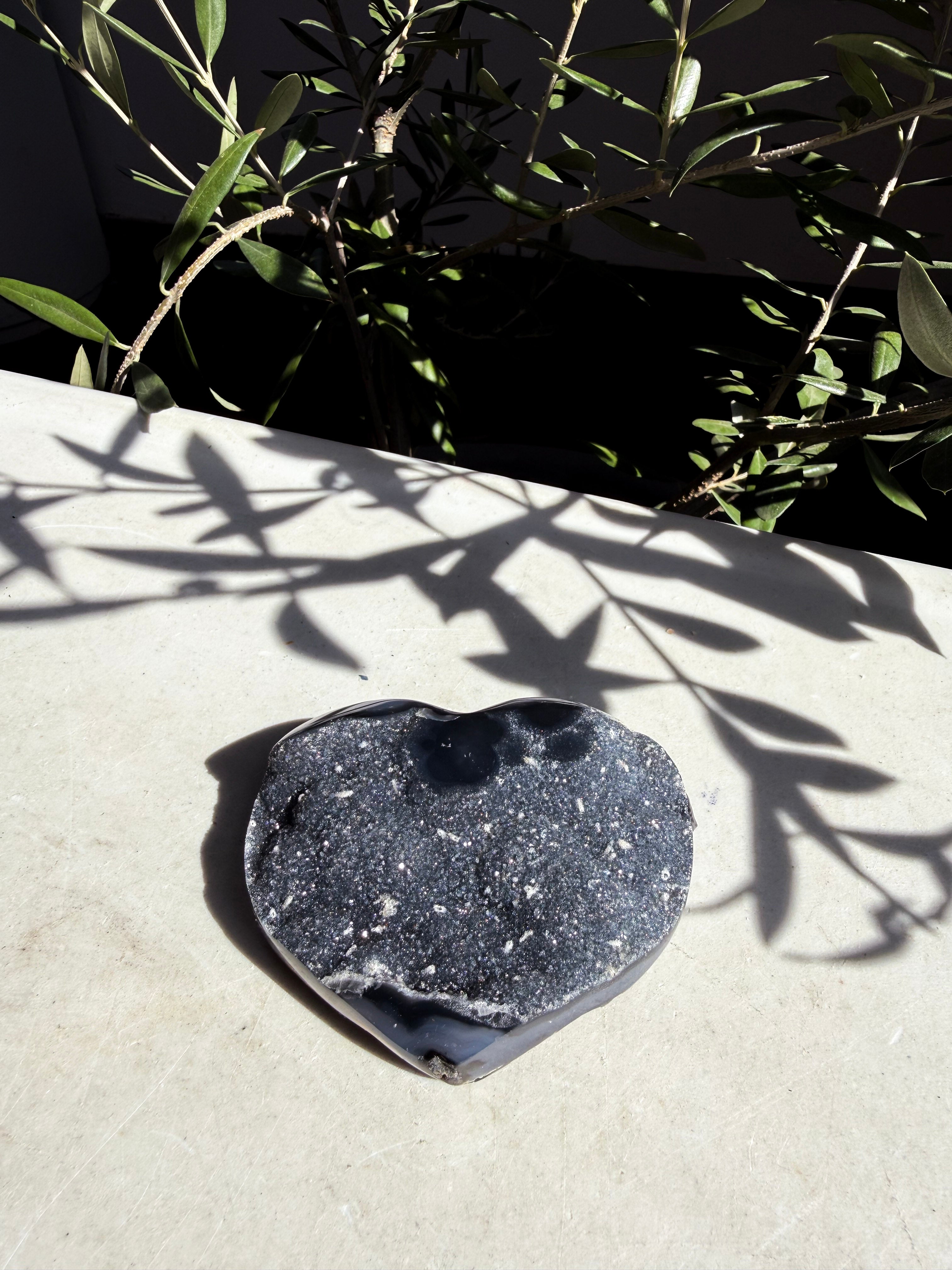 navy druzy agate heart on marble background