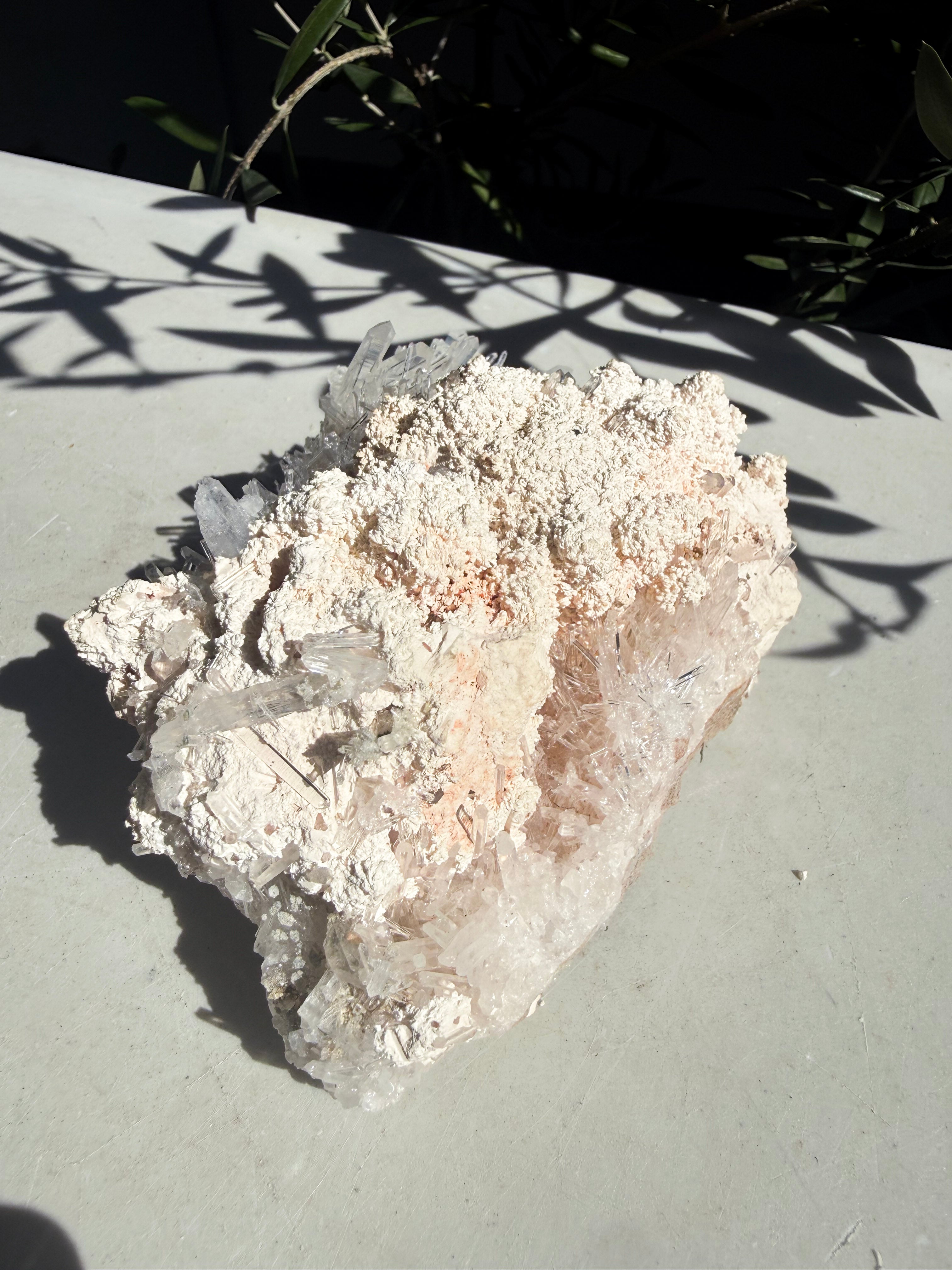 Unique needle quartz specimen on counter