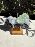 Fujian Seafoam Fairy Fluorite Quartz on wooden and metal stand