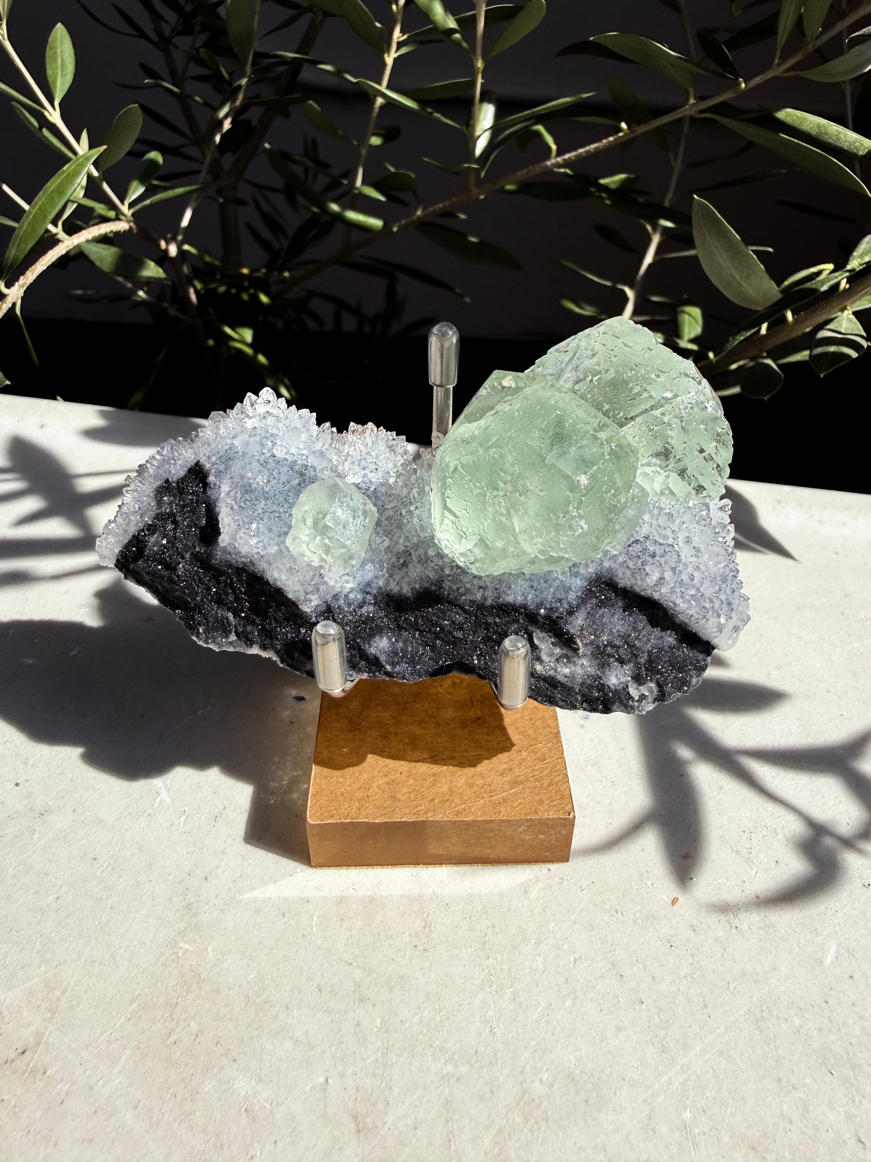 Fujian Seafoam Fairy Fluorite Quartz on wooden and metal stand