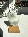 small fujian fluorite druzy quartz on wooden and metal stand on marble counter