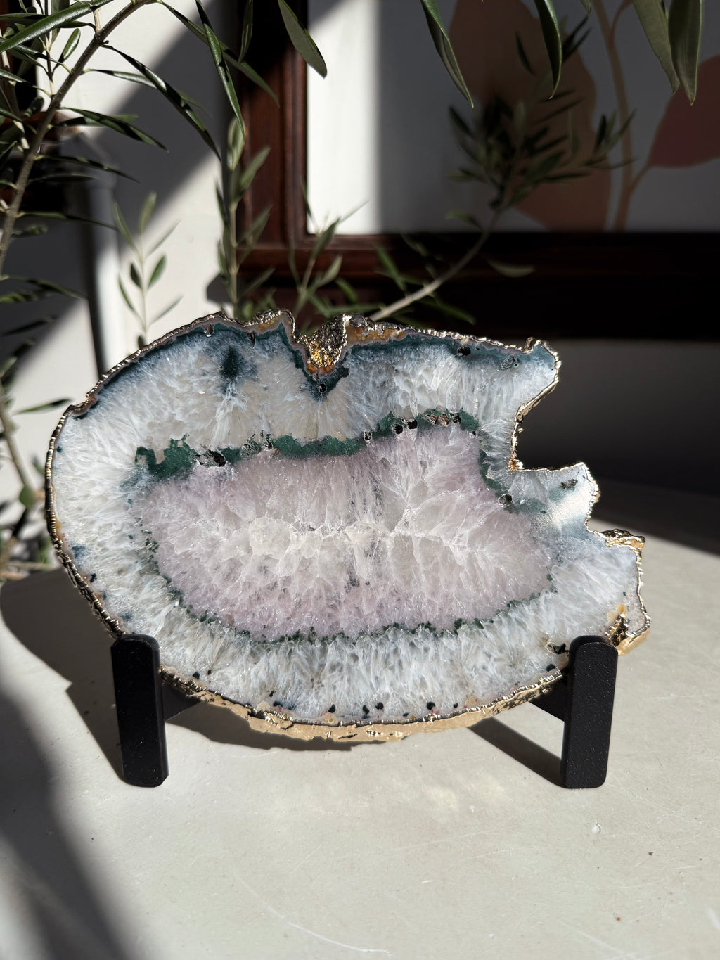 agate slice with green and light amethyst center on stand