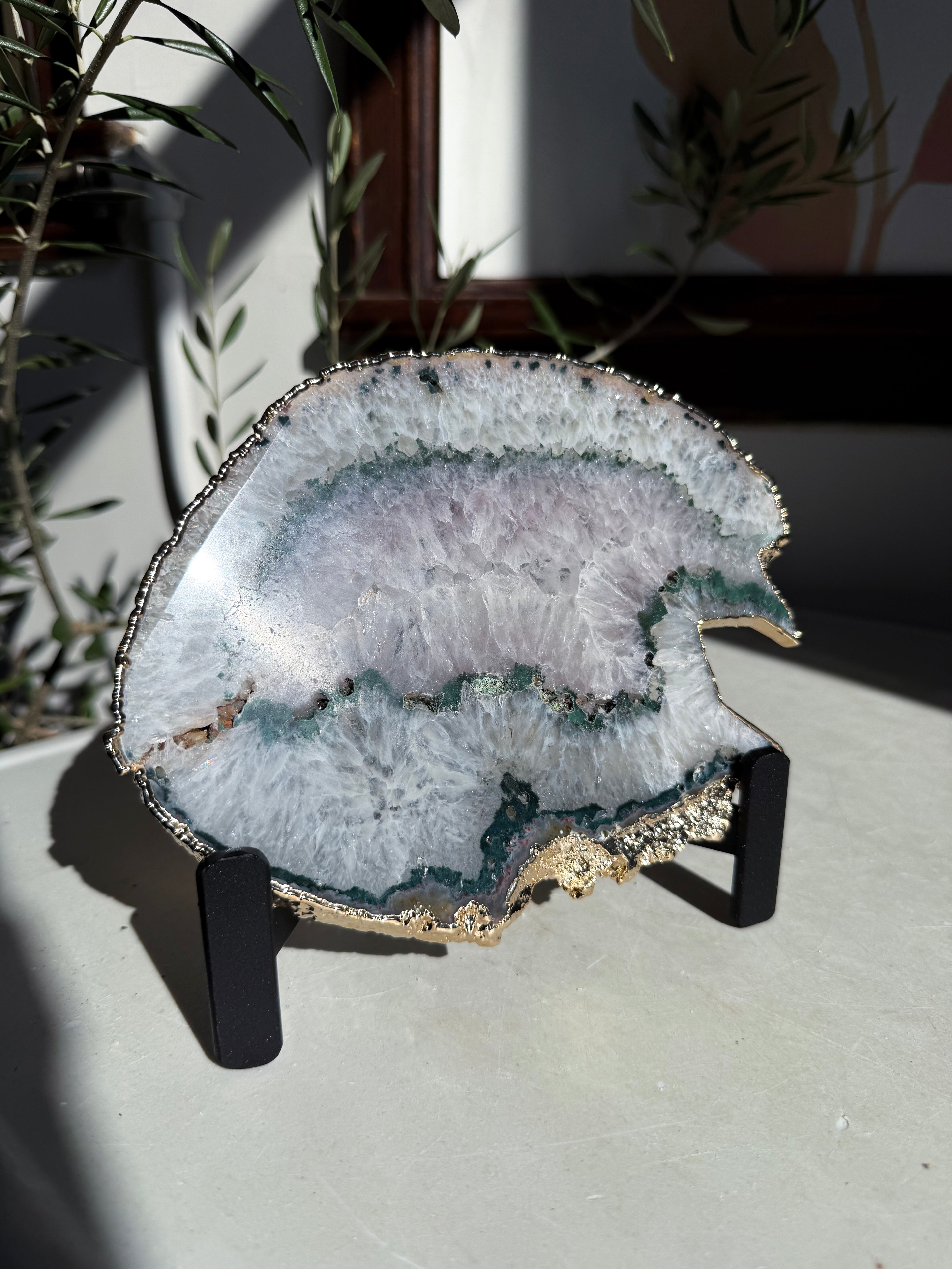 agate slice with green and amethyst center on stand