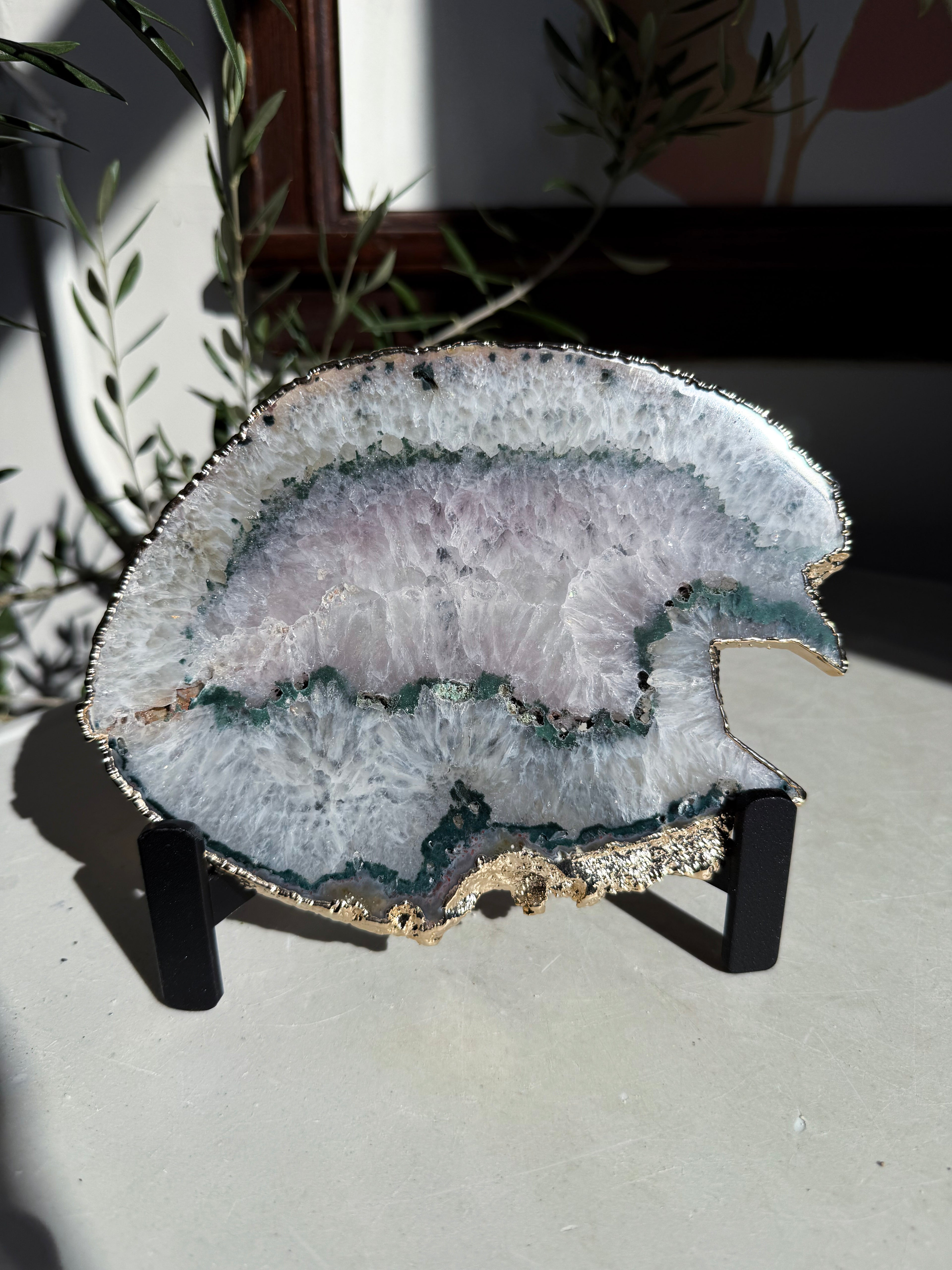 agate slice with green banding and light amethyst center on stand