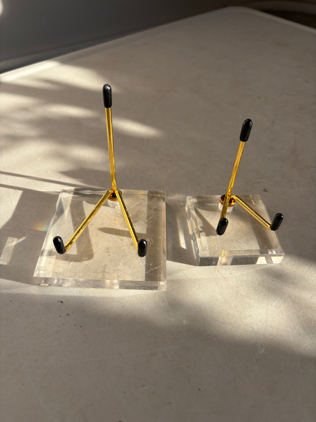 two gold stands with Acrylic Bases