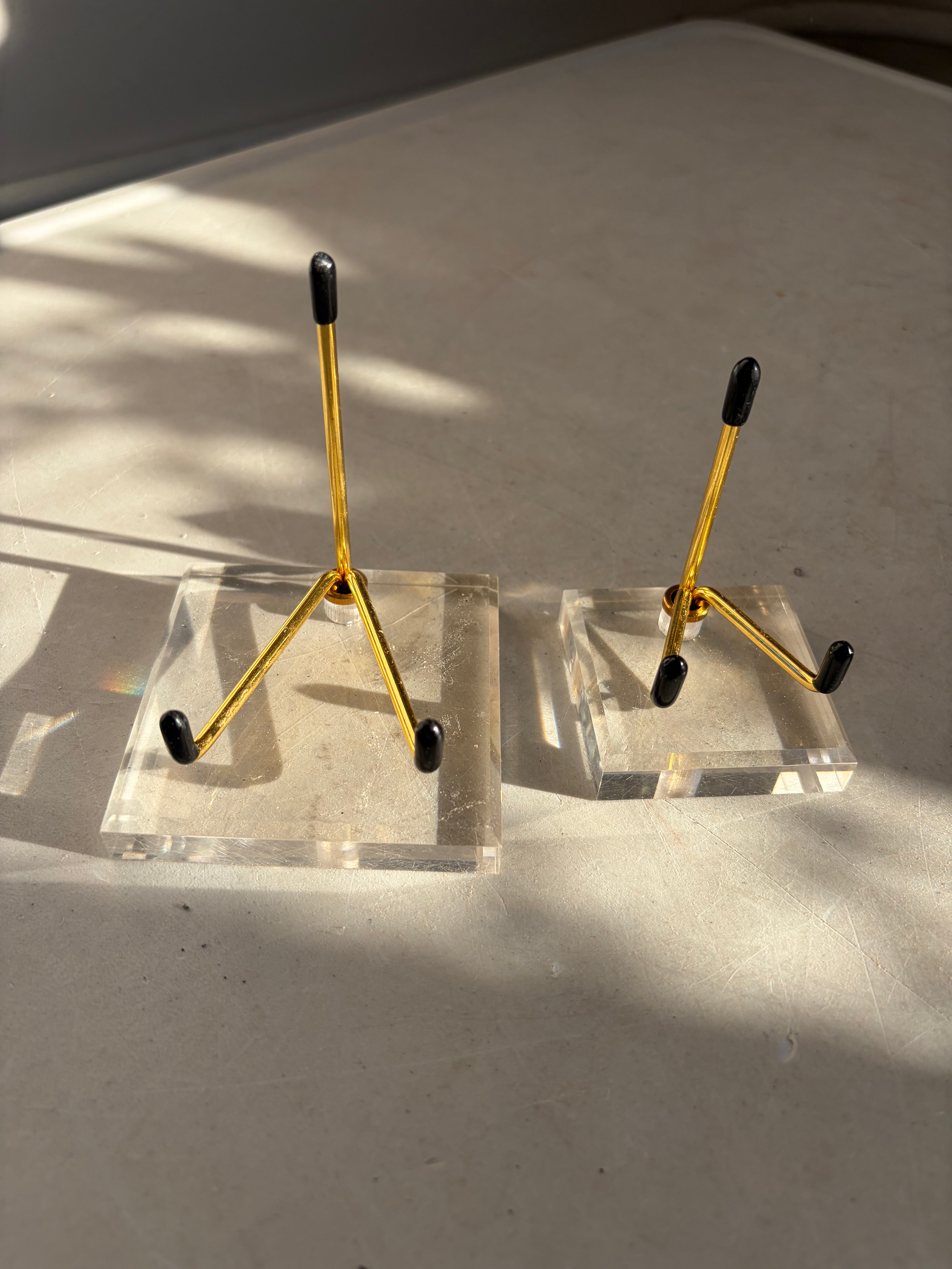two gold stands with Acrylic Bases