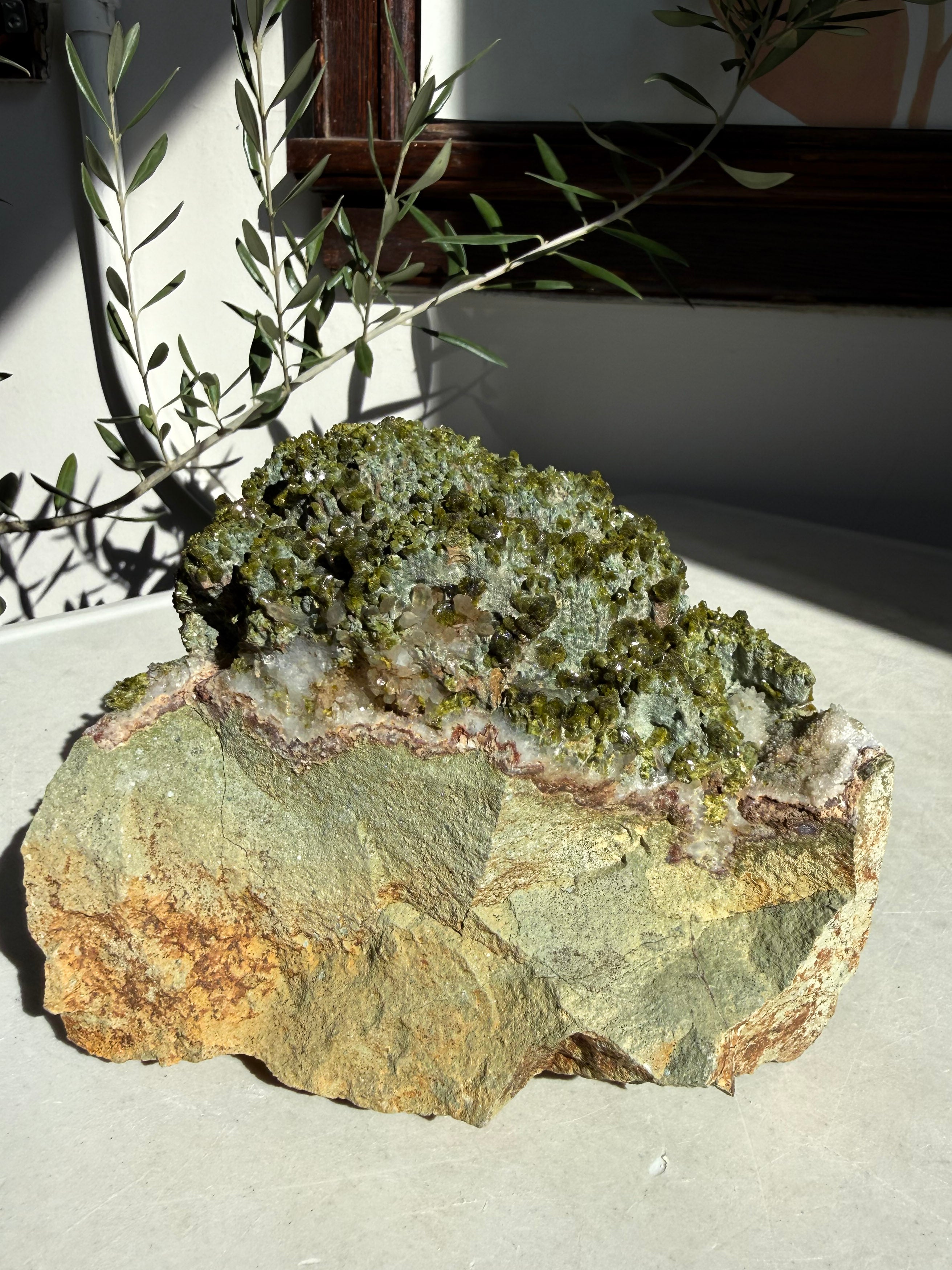 profile view of large statement epidote and quartz on marble counter