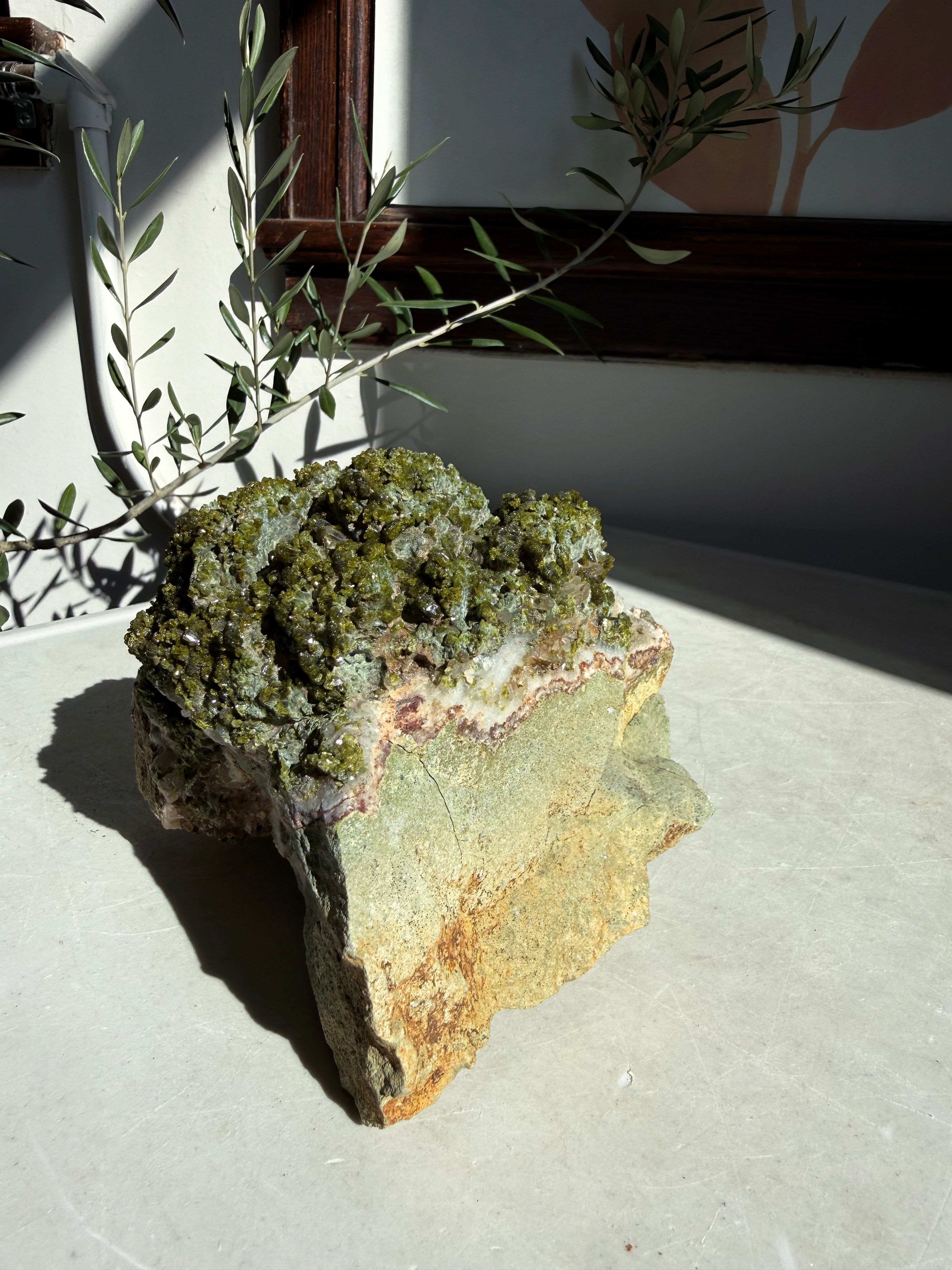 large statement epidote and quartz on marble counter