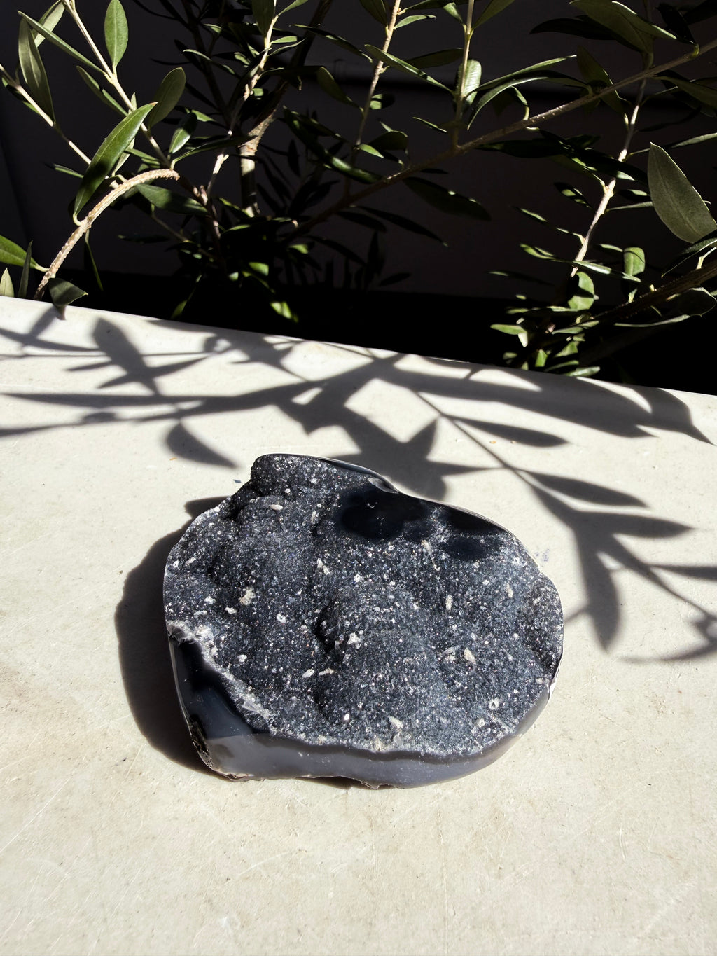 raw agate navy heart on white marble background