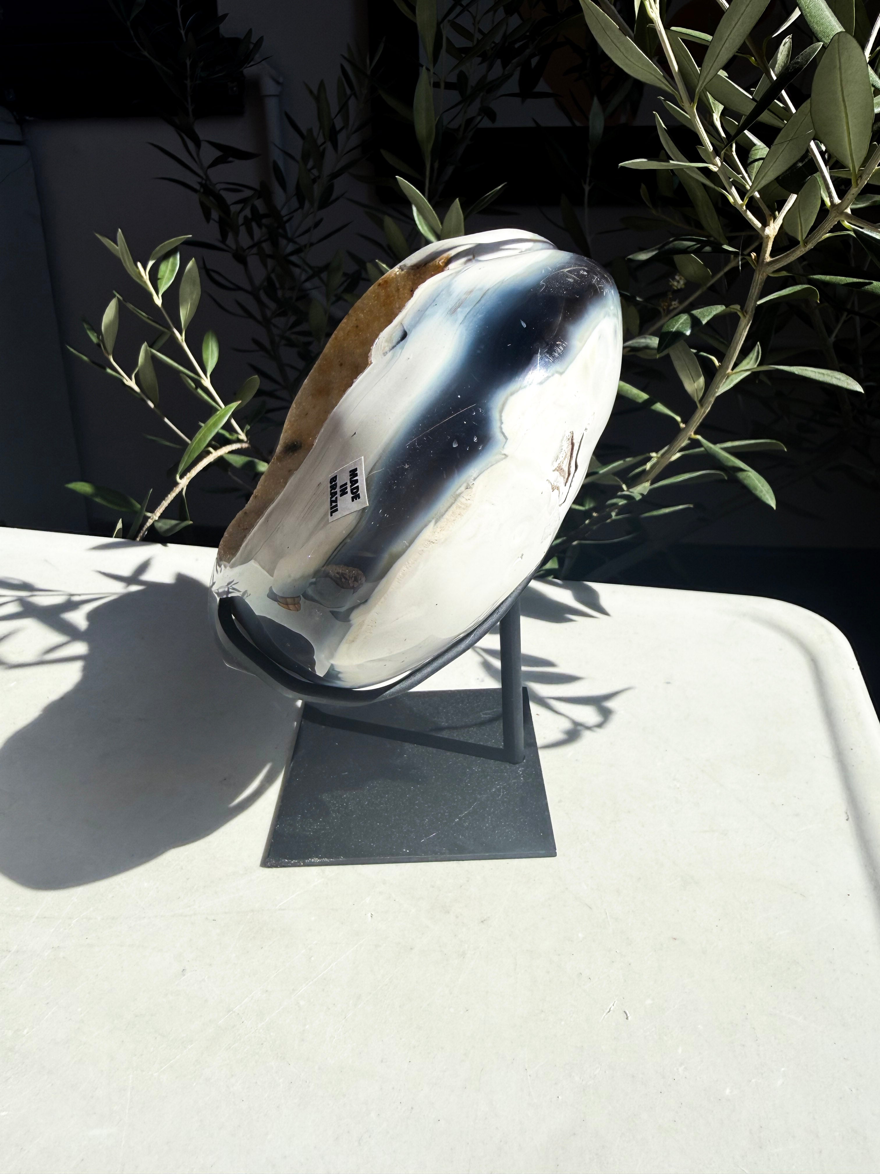 side view of polished orca agate heart