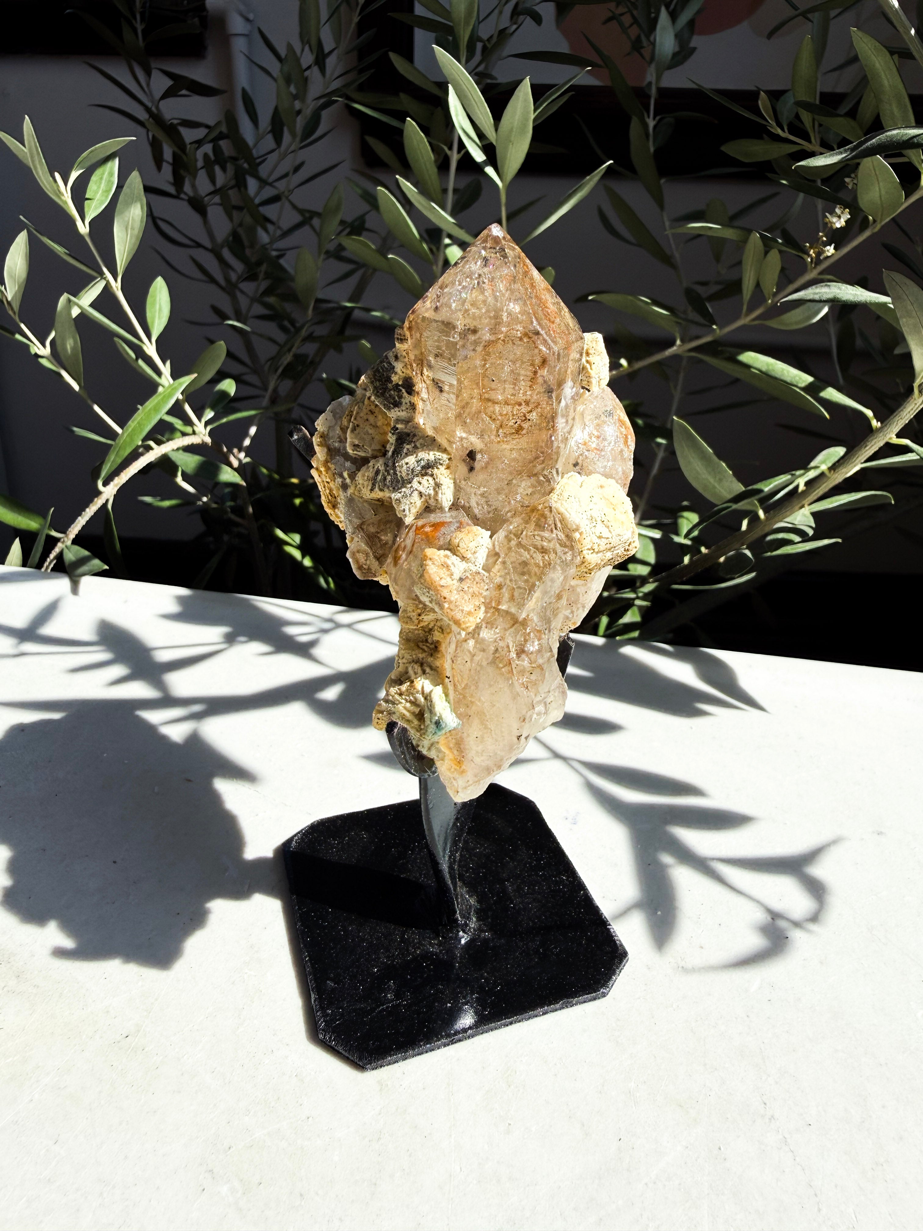 smoky quartz and lepidolite on custom stand sitting on marble counter