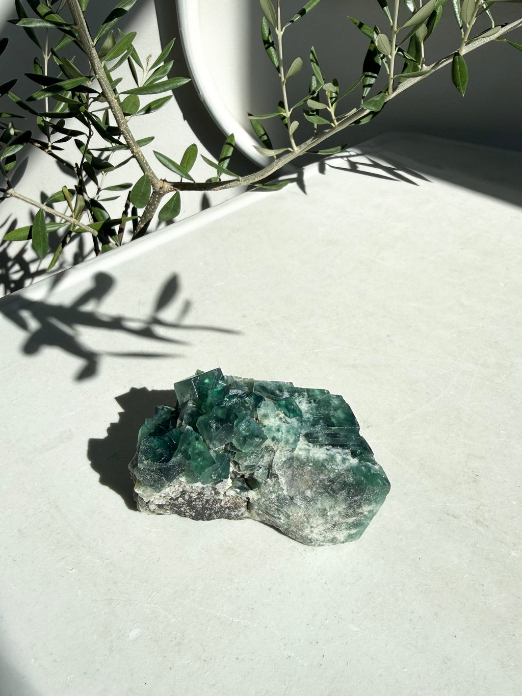 natural bright green fluorite on marble counter 