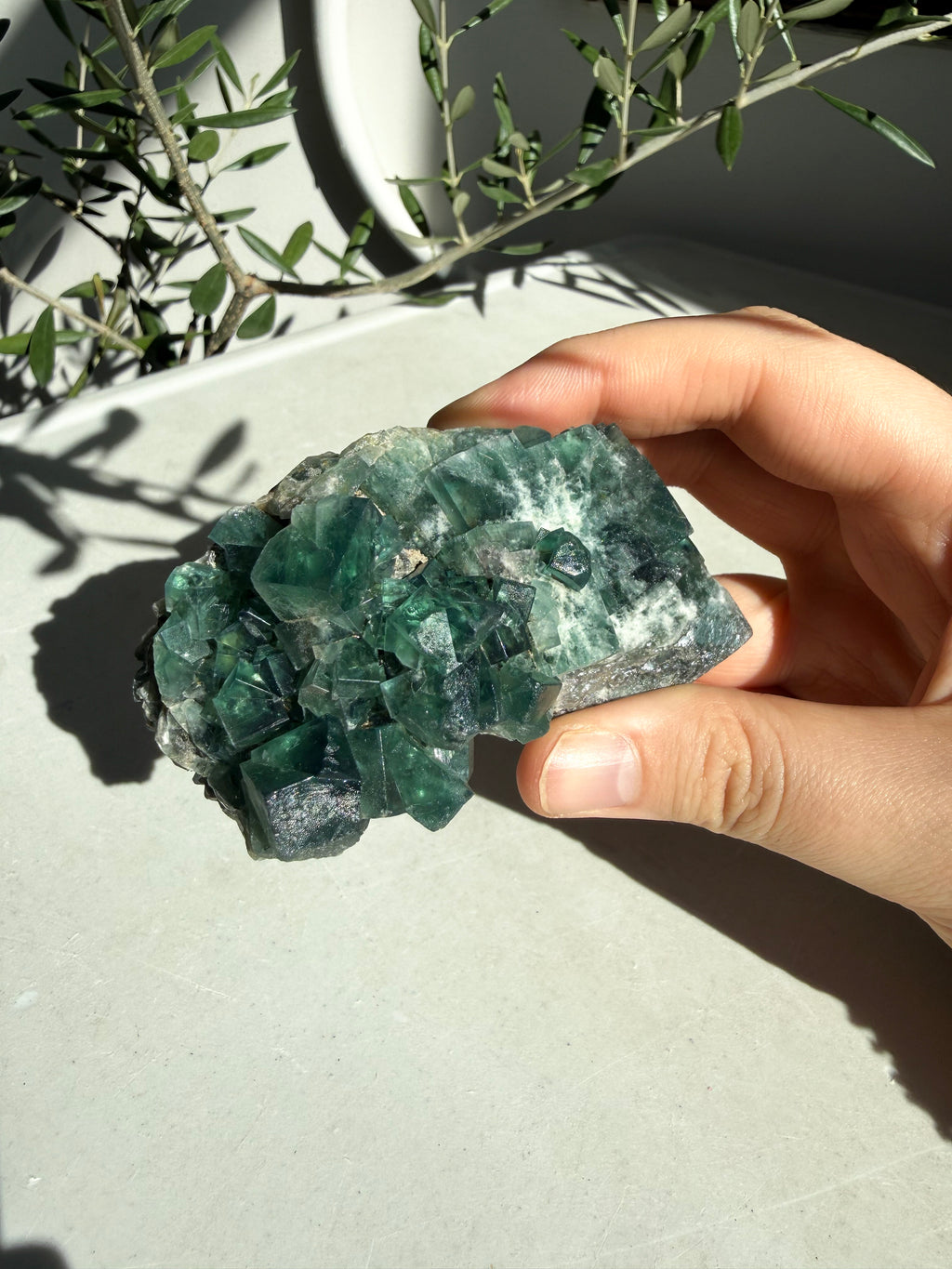 hand holding bright green flourite 