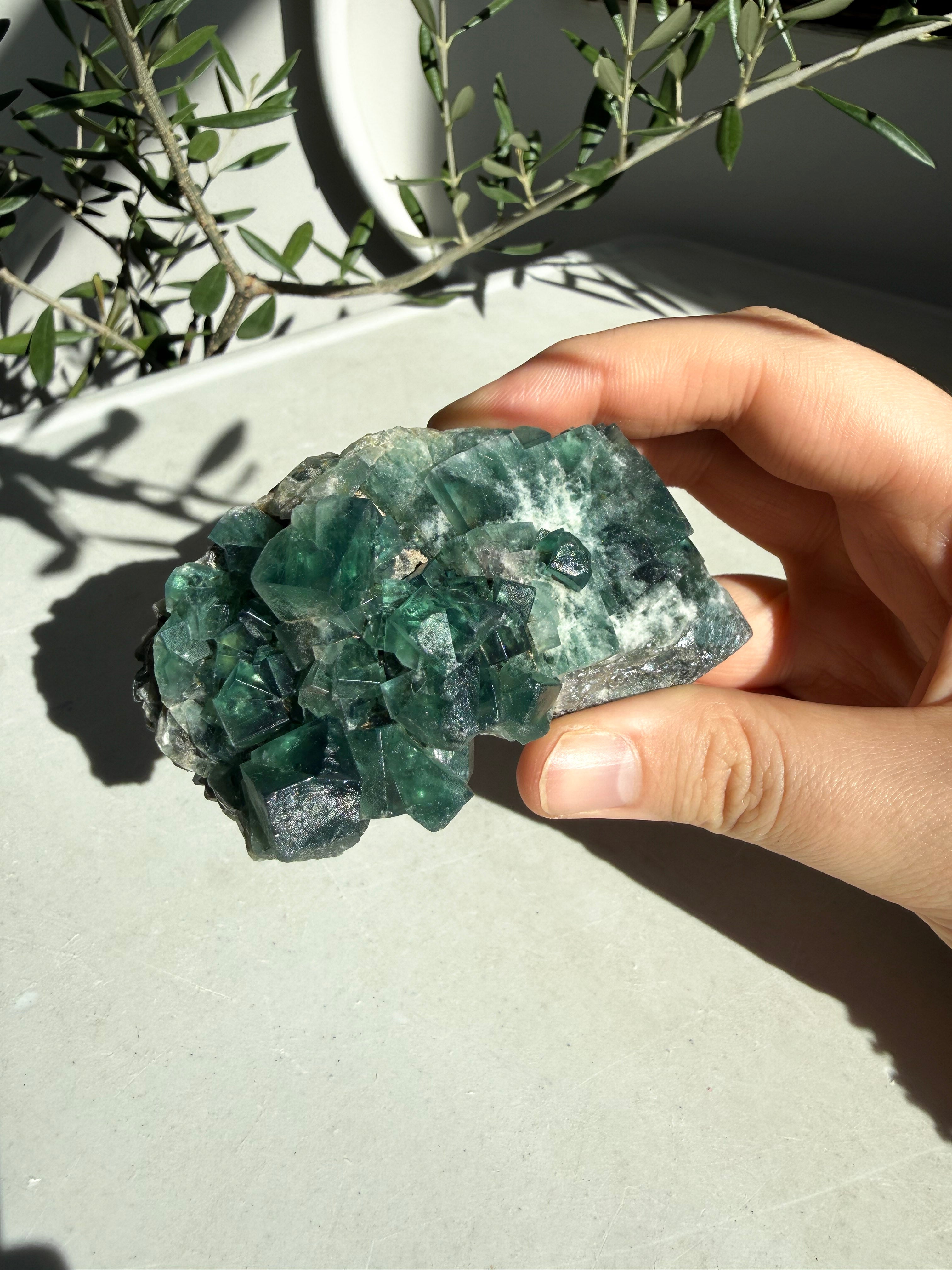 hand holding bright green flourite 