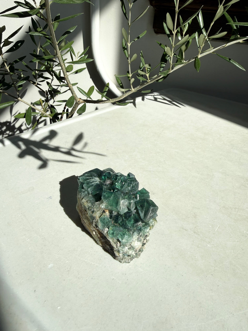 green fluorite on white marble countertop
