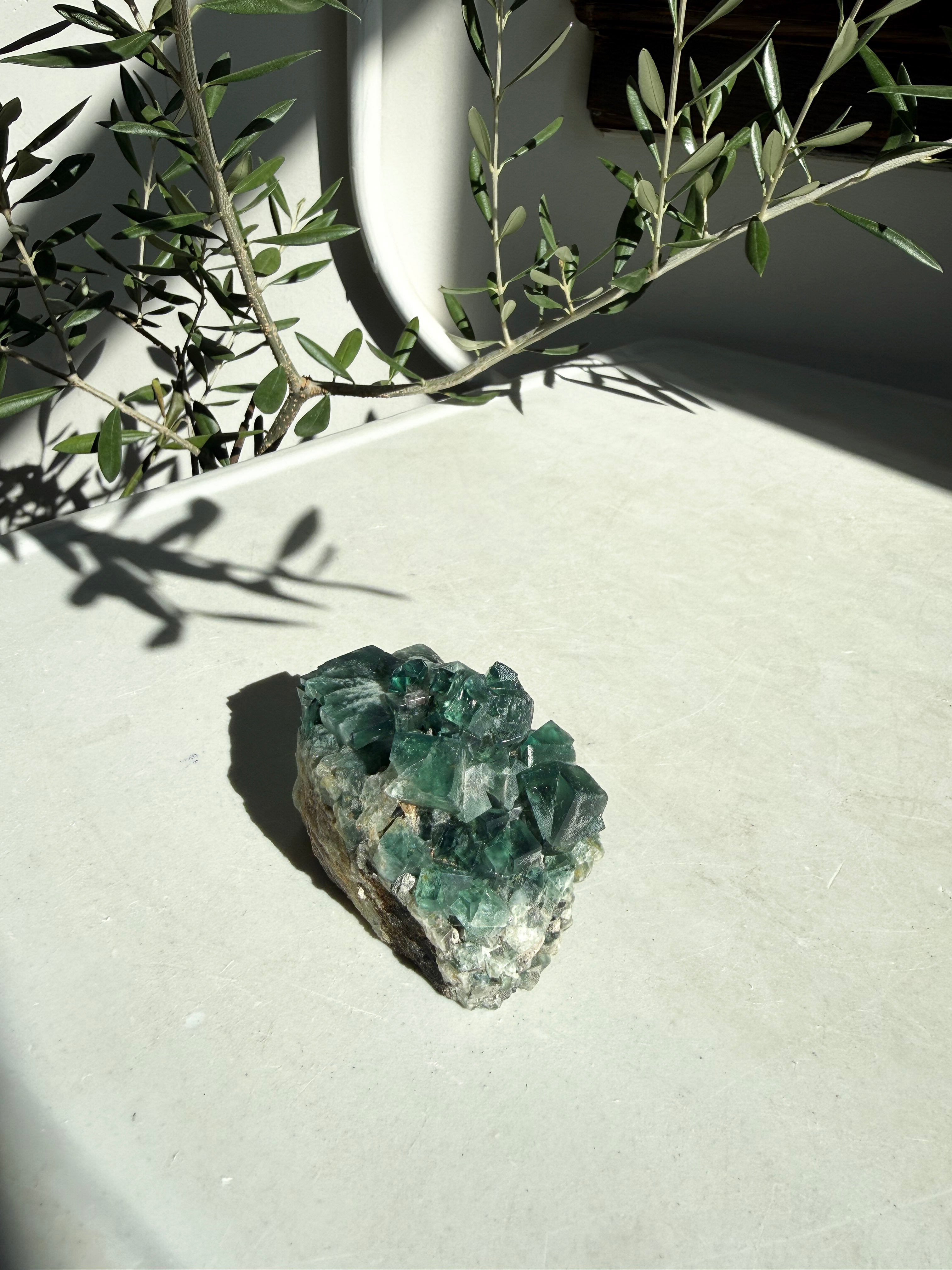 green fluorite on white marble countertop